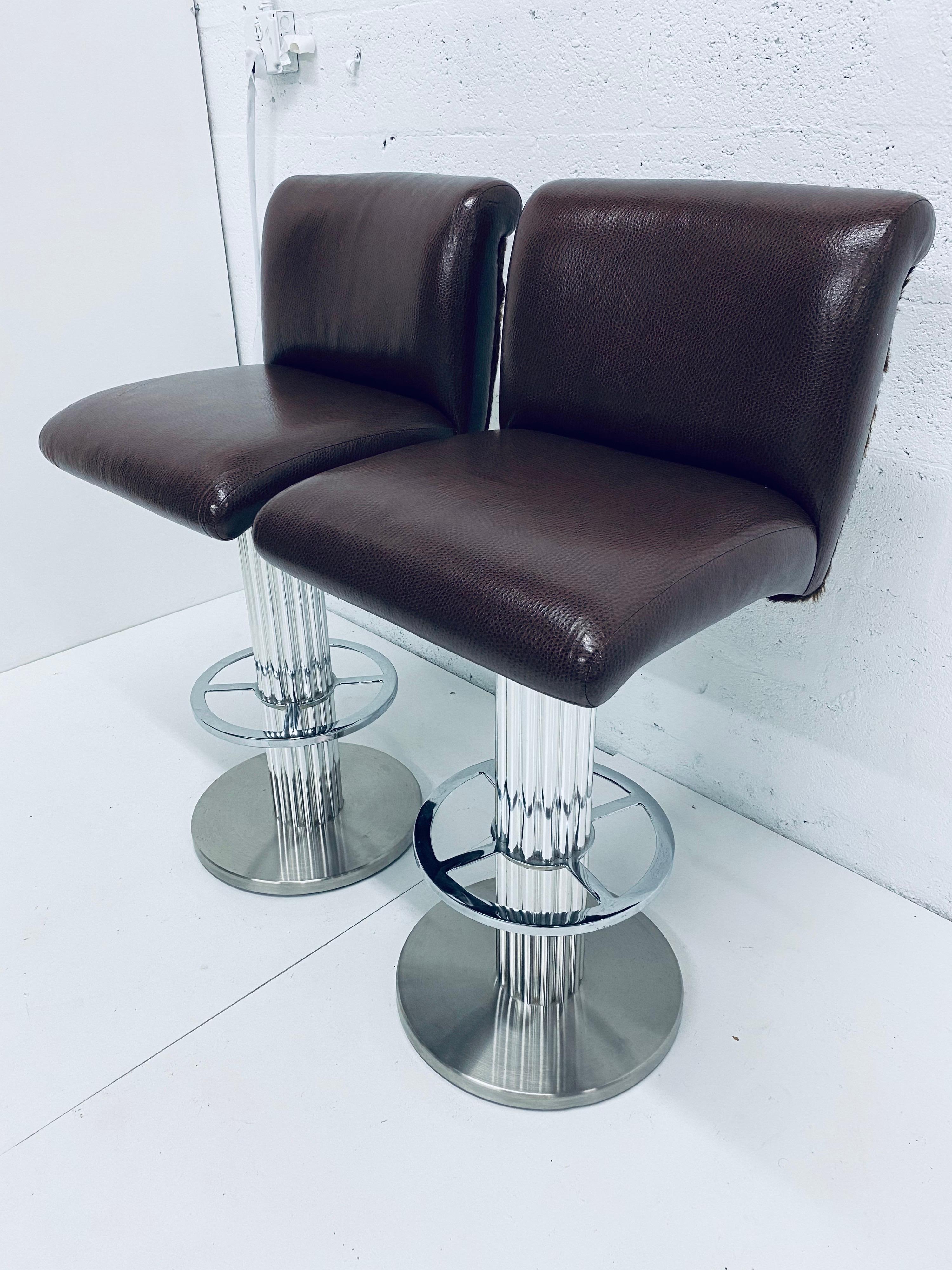 Pair of faux leather and fur bar stools on swivel bases by Designs for Leisure. The swivel returns seat to original position for a consistent look when not being used. A true Art Deco Revival design from the late 20th century. Use as is or have