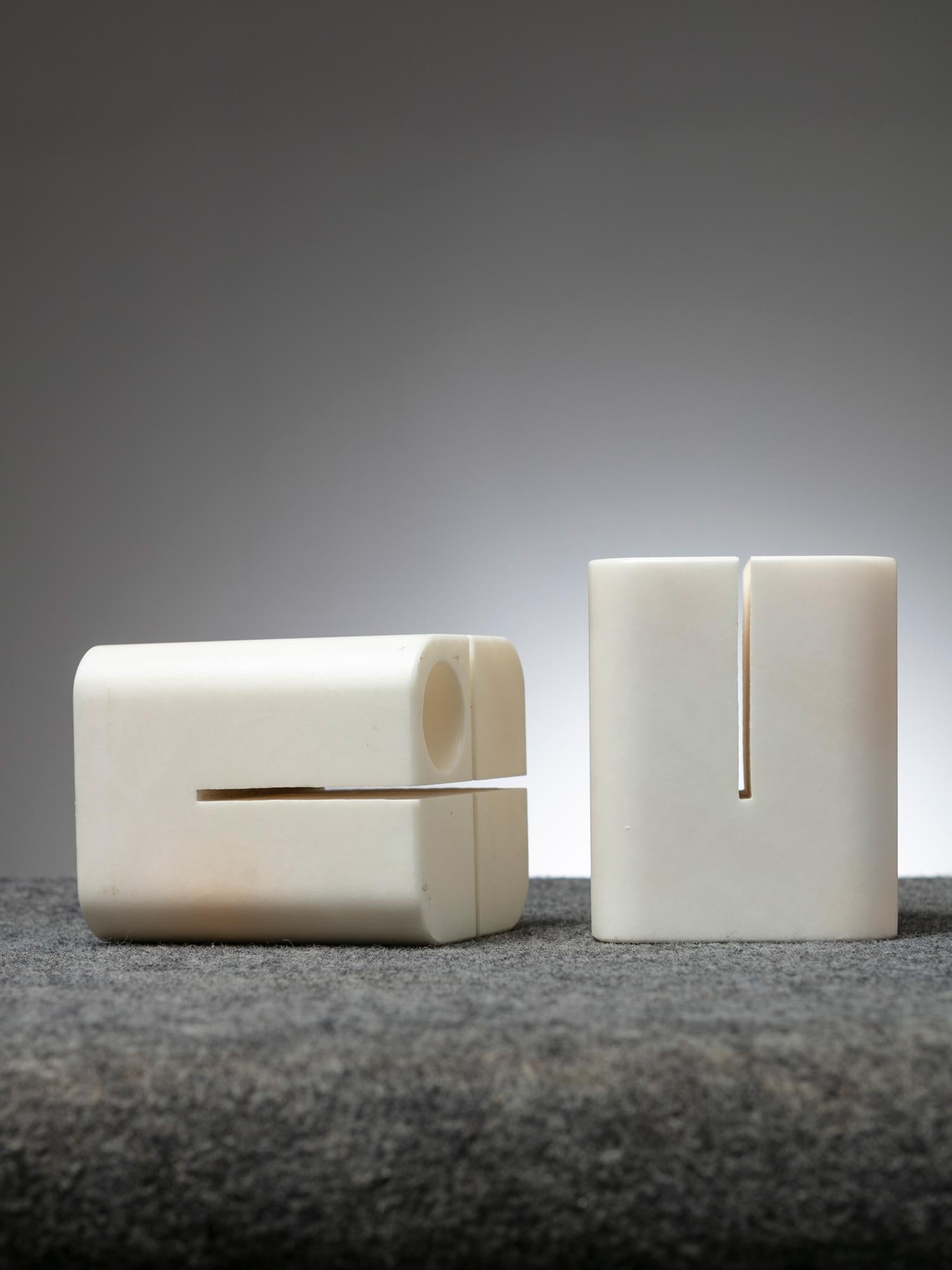 Set of two stone pieces by Lelo Cremonesi.
Two orthogonal cuts and a round hole for several possible functions.