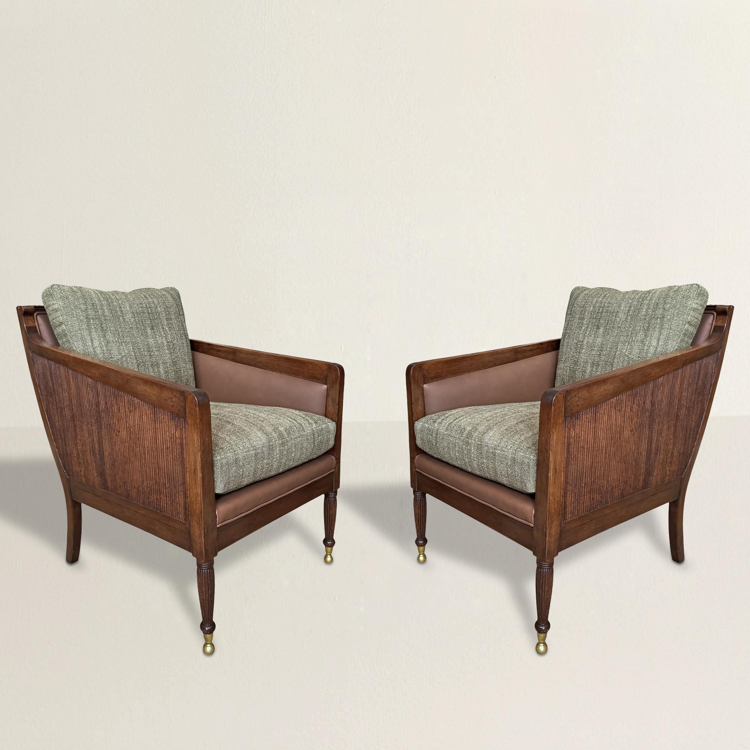 A study in restraint and polish, this pair of early 21st-century Nelson Bergère chairs by Dessin Fournir borrows from Edwardian England but lands firmly in the now. The mahogany frames are crisp and architectural, with reeded sides and legs that