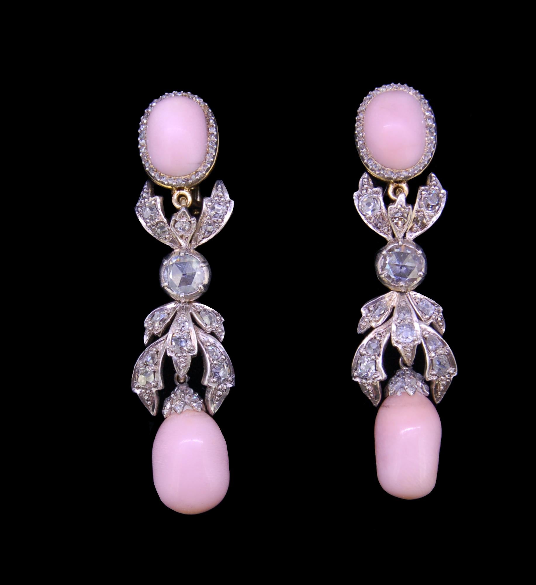IMPORTANT PAIR OF DIAMOND AND CONCH PEARL DROP EARRINGS, the tops set with a conch pearl surrounded by diamonds, suspending a scrolling diamond set mid section suspending a large conch pearl drop. L. 5.5 cm. 18.2 grams. With a fitted box.
