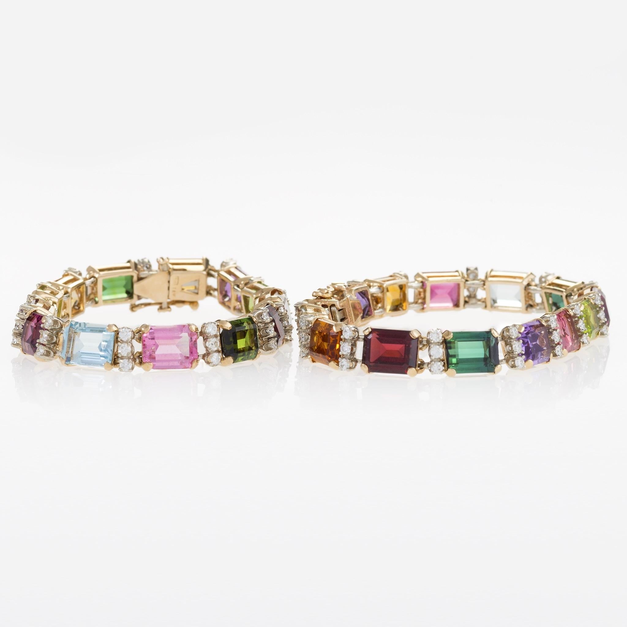 A pair of 14 karat gold bracelets with diamonds and multi-colored gemstones. The bracelets have 81 round brilliant-cut diamonds with an approximate total weight of 3.25 carats, and 27 9mm x 7mm rectangular-cut stones including Amethyst, Citrine,