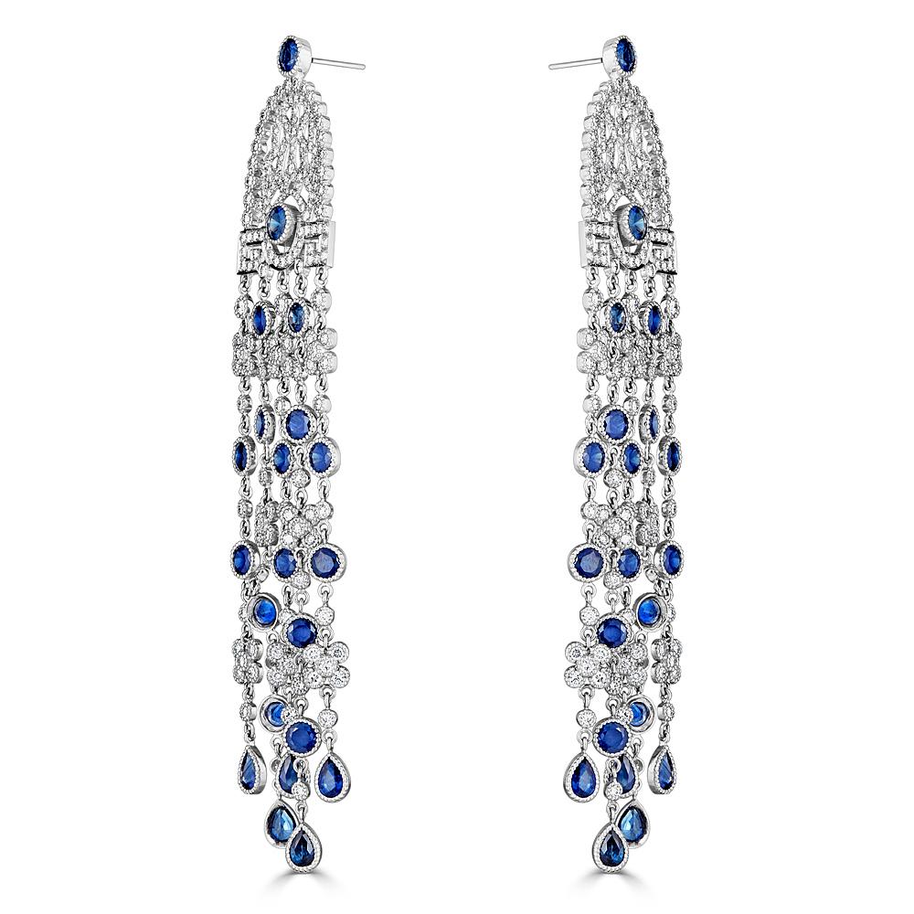 A stunning pair of Diamond and Natural Blue Sapphire Cascade Chandelier Earrings featuring 8.30 carats of G/H Color Si Clarity Diamonds and 18.80 carats of Natural Blue Sapphires. These earrings hang at a shoulder dusters length of 5 inches and