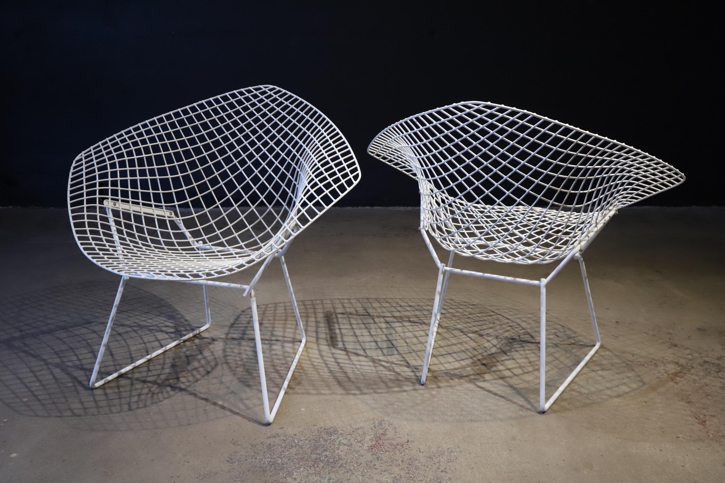 Pair of white diamond chairs by Harry Bertoia for Knoll. Original condition. Diamonds are timeless & always collectible. Photographed with Saarinen tulip stool for scale. Total of four chairs available (two shown in this listing)