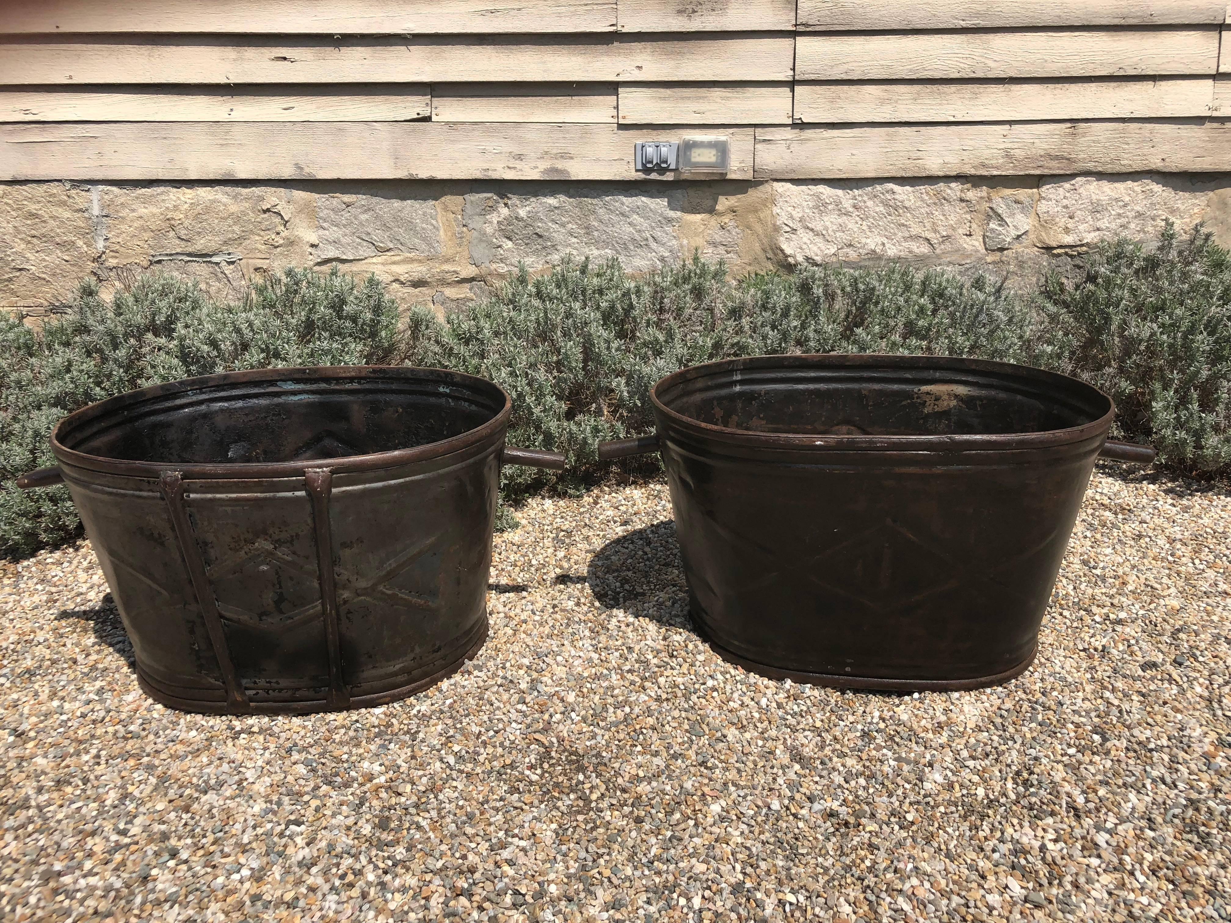 This pair of steel wine-harvest buckets has been burnished to a stunning patina and would make wonderful planters or accessories in your wine cellar. From Burgundy, they both have a wonderful raised diamond-shaped design on the exterior and are