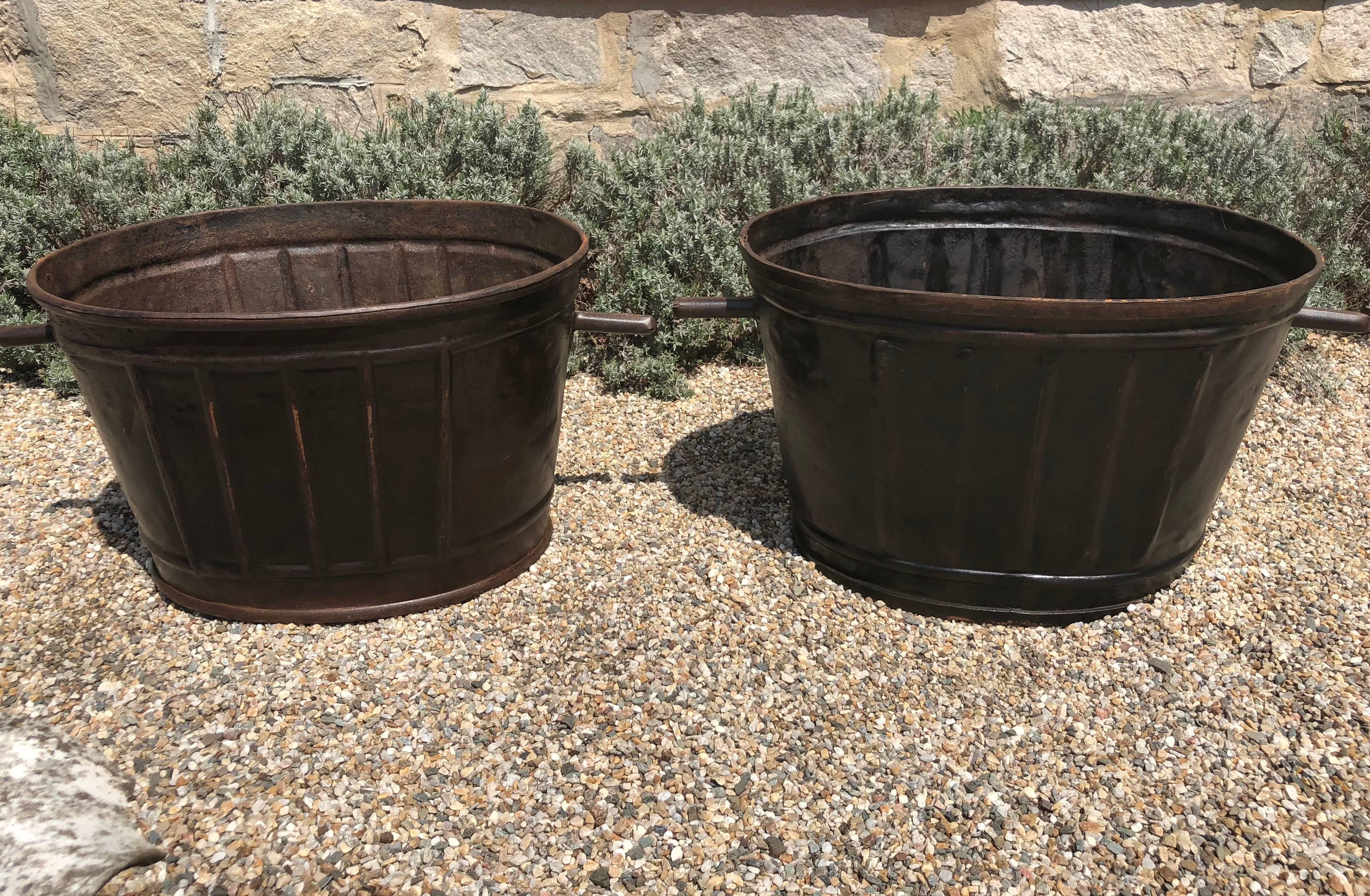 This pair of steel wine-harvest buckets has been burnished to a stunning patina and would make wonderful planters or accessories in your wine cellar. From Burgundy, they both have a wonderful raised diamond-shaped design on the exterior and are