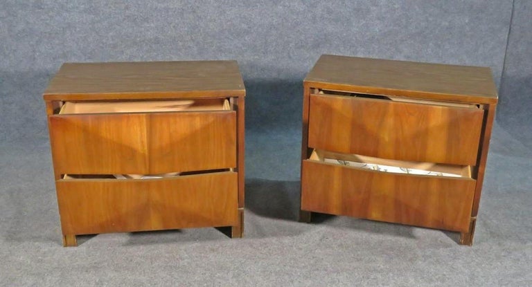 With an understated, simple design and a rich walnut woodgrain, this pair of diamond front night stands are styled after mid-century furniture maker Johnson Carper. Two dovetailed drawers open to spacious compartments. Please confirm item location