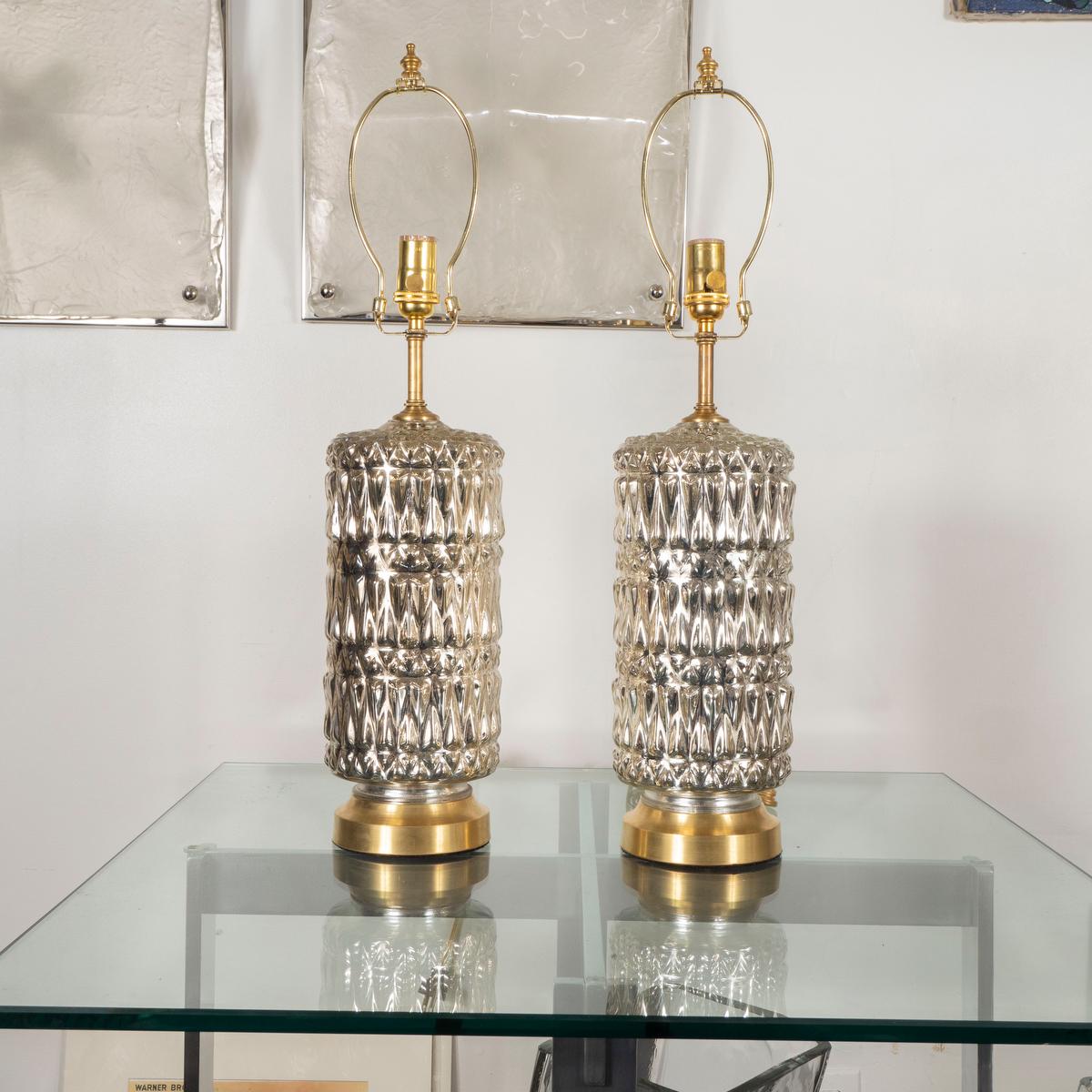 Pair of cylindrical molded mercury glass lamps with diamond pattern.