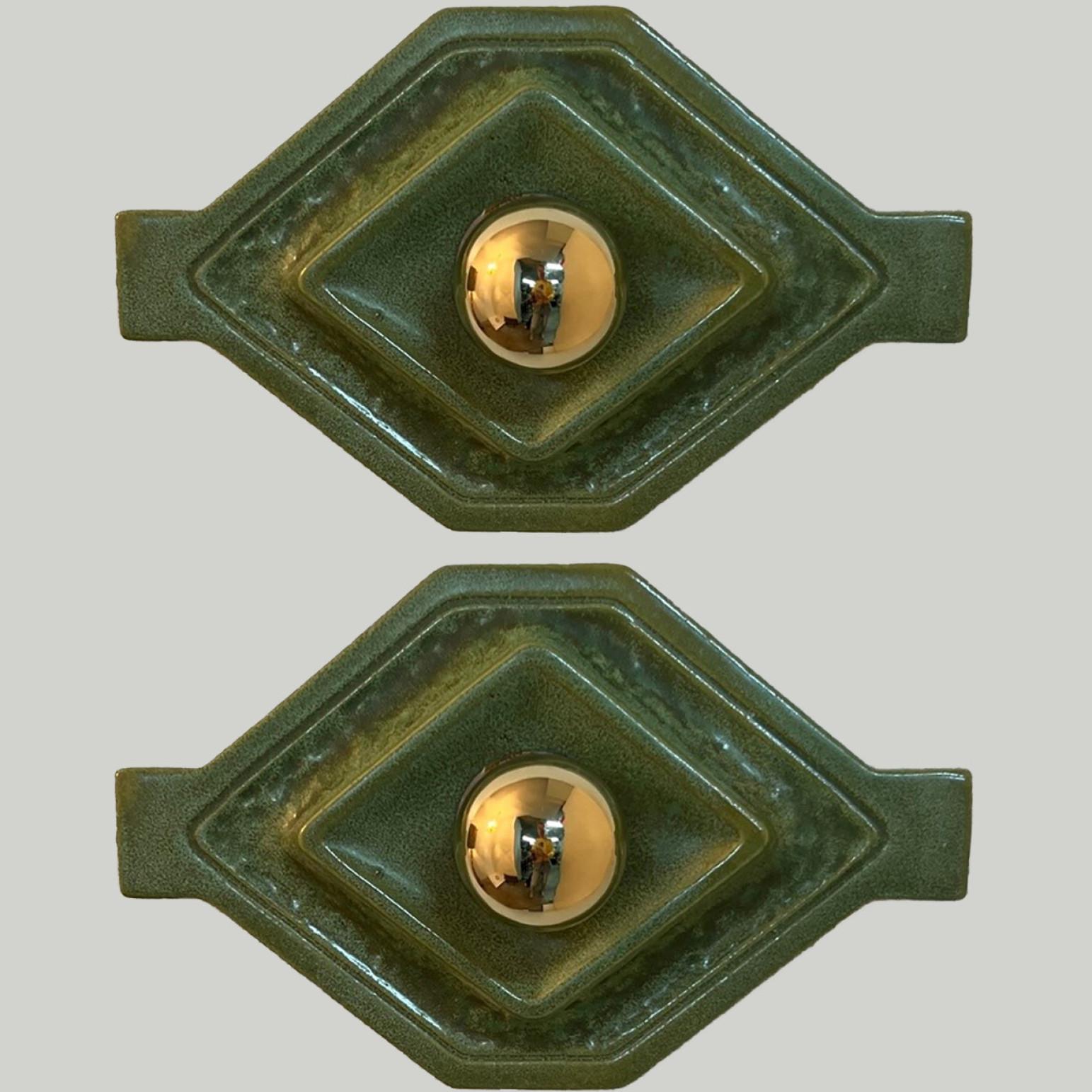 Diamond-shaped green ceramic wall lights in Fat Lava style. Manufactured by Hustadt Leuchten Keramik, Germany in the 1970s.

The style of the glaze is called 'Fat Lava'. Which means the glaze is thick on some parts, like lava.
A typical way to