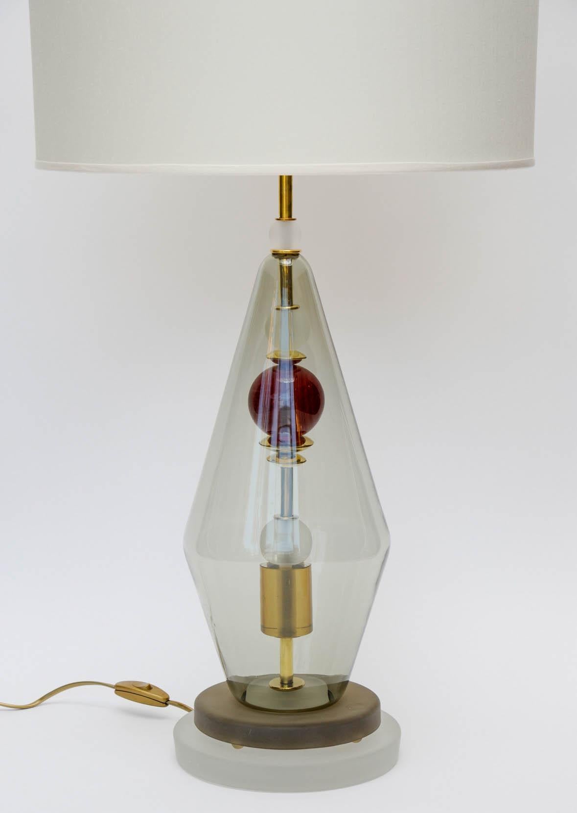 Pair of nice Murano glass table lamps made of a hollow diamond shaped centerpiece in which are threaded multiple Murano coloured parts.

Brass neck, new electrification.