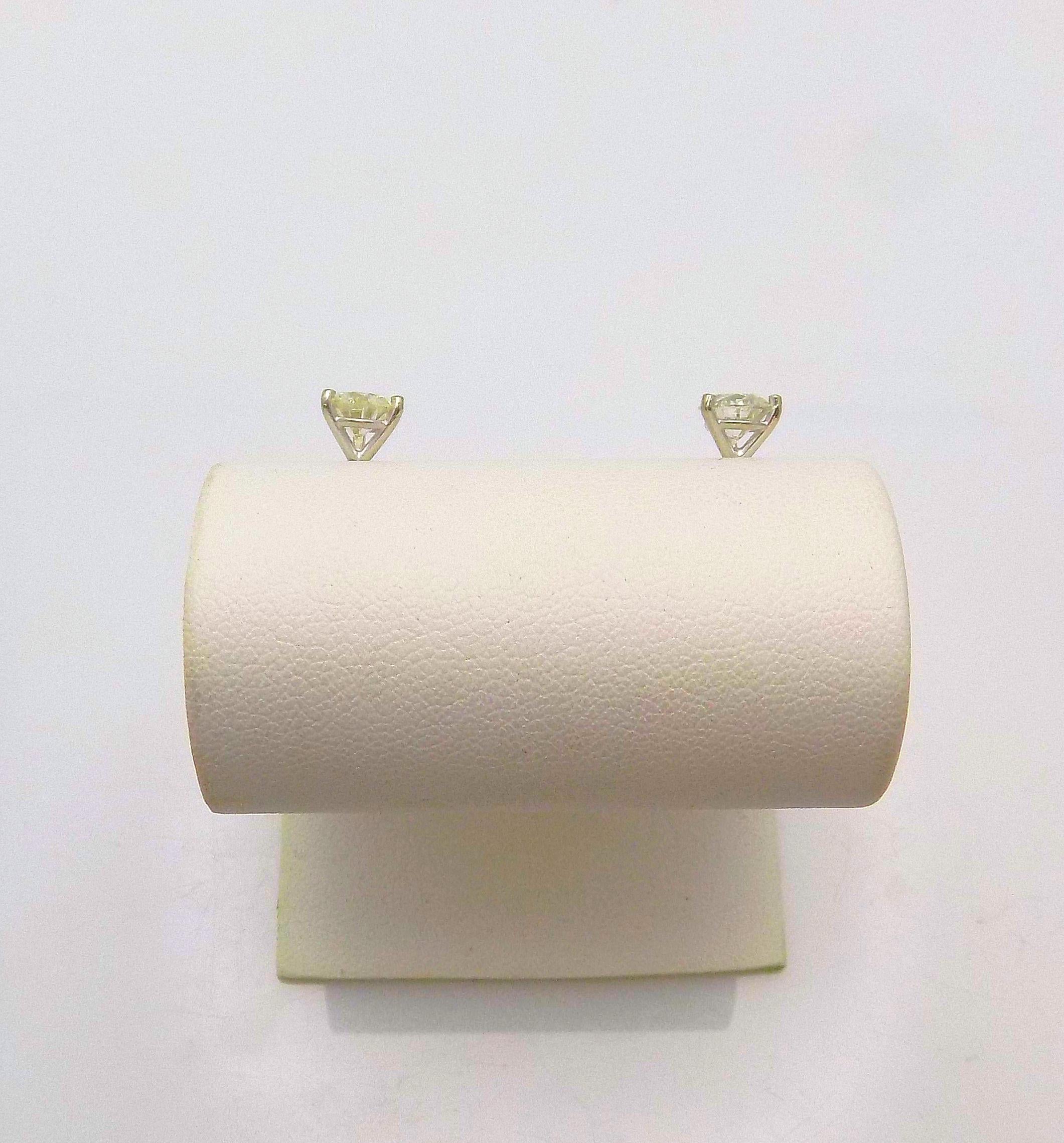 Pair 14 Karat White Gold Diamond Earrings, Martini Setting featuring 2 Round Brilliant Diamonds 1.60 Carat Total Weight; SI-3, J-K; Sterling Silver Backs, 1.0 DWT or 1.56 Grams.