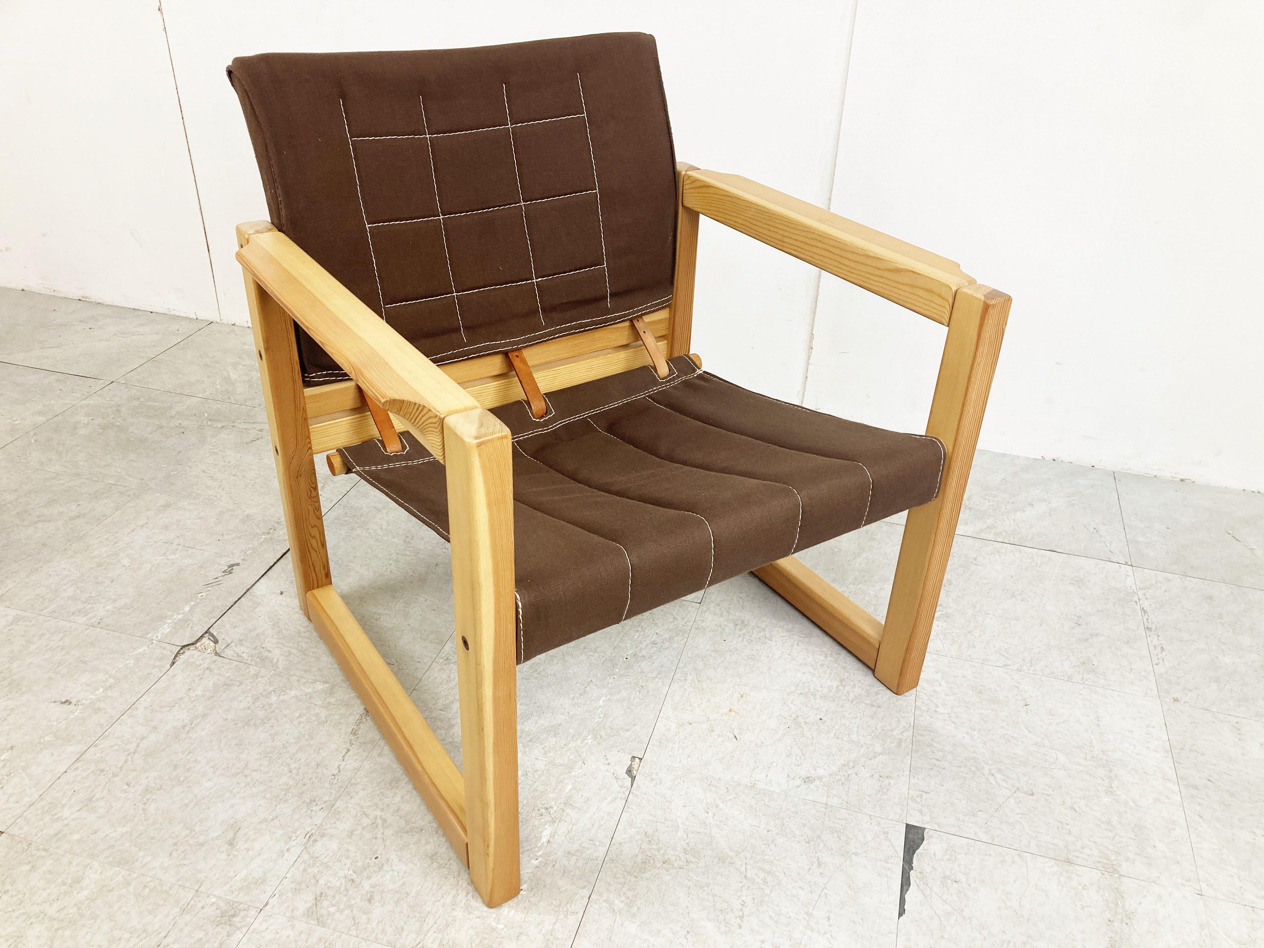 Charming pair of so called 'safari' armchairs designed by Karin Mobring for Ikea. The chair's model name is 'Diana'

Made from solid pine wood frames with brown fabric canvas upholstery.

A nice design feature are the leather straps at the