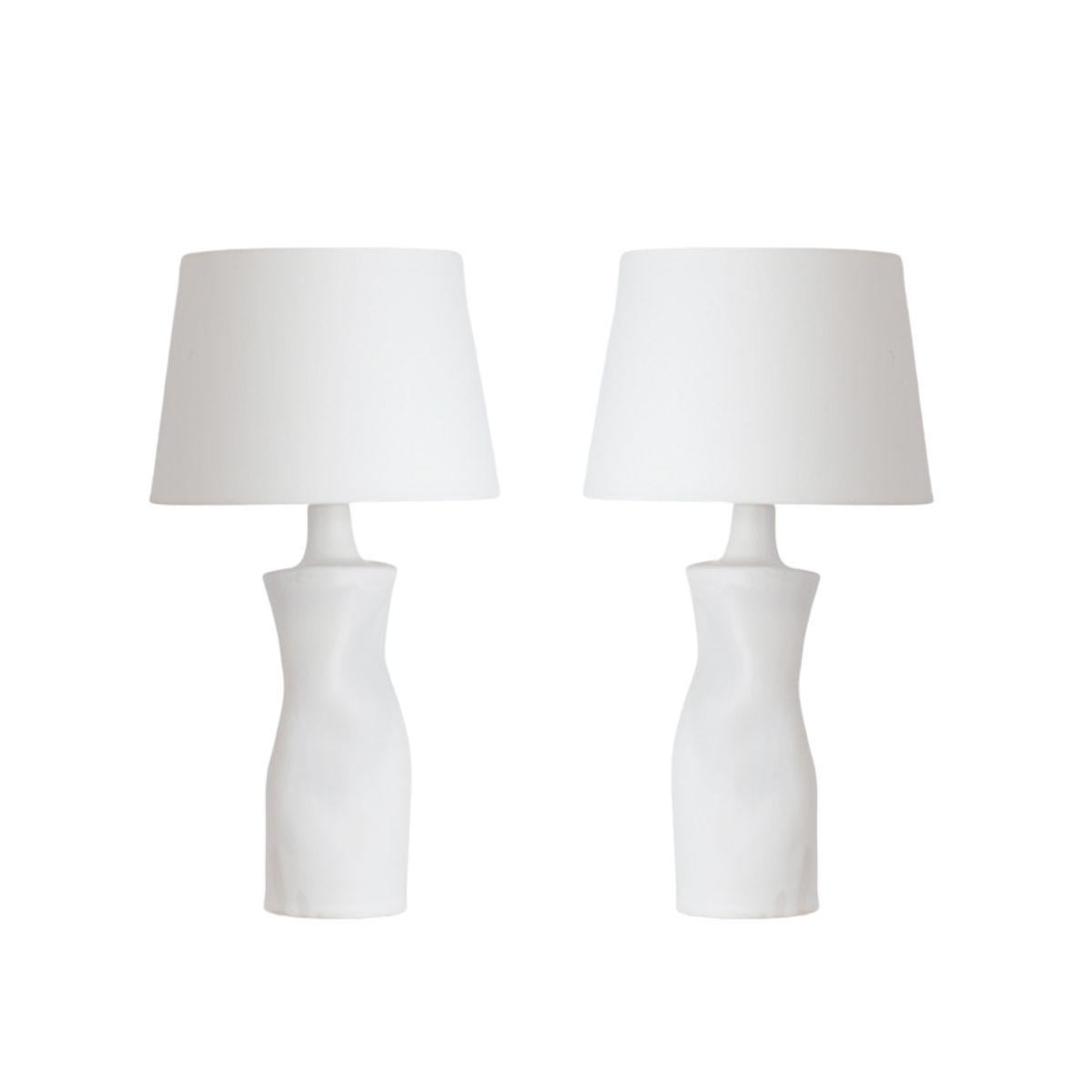 'Difforme' white ceramic table lamps with parchment shades by Design Frères.

Wired with high-end twist cords and 3-way switches (on, half intensity, off).  40w filament bulbs are included in your order. The European style parchment shades (no harp