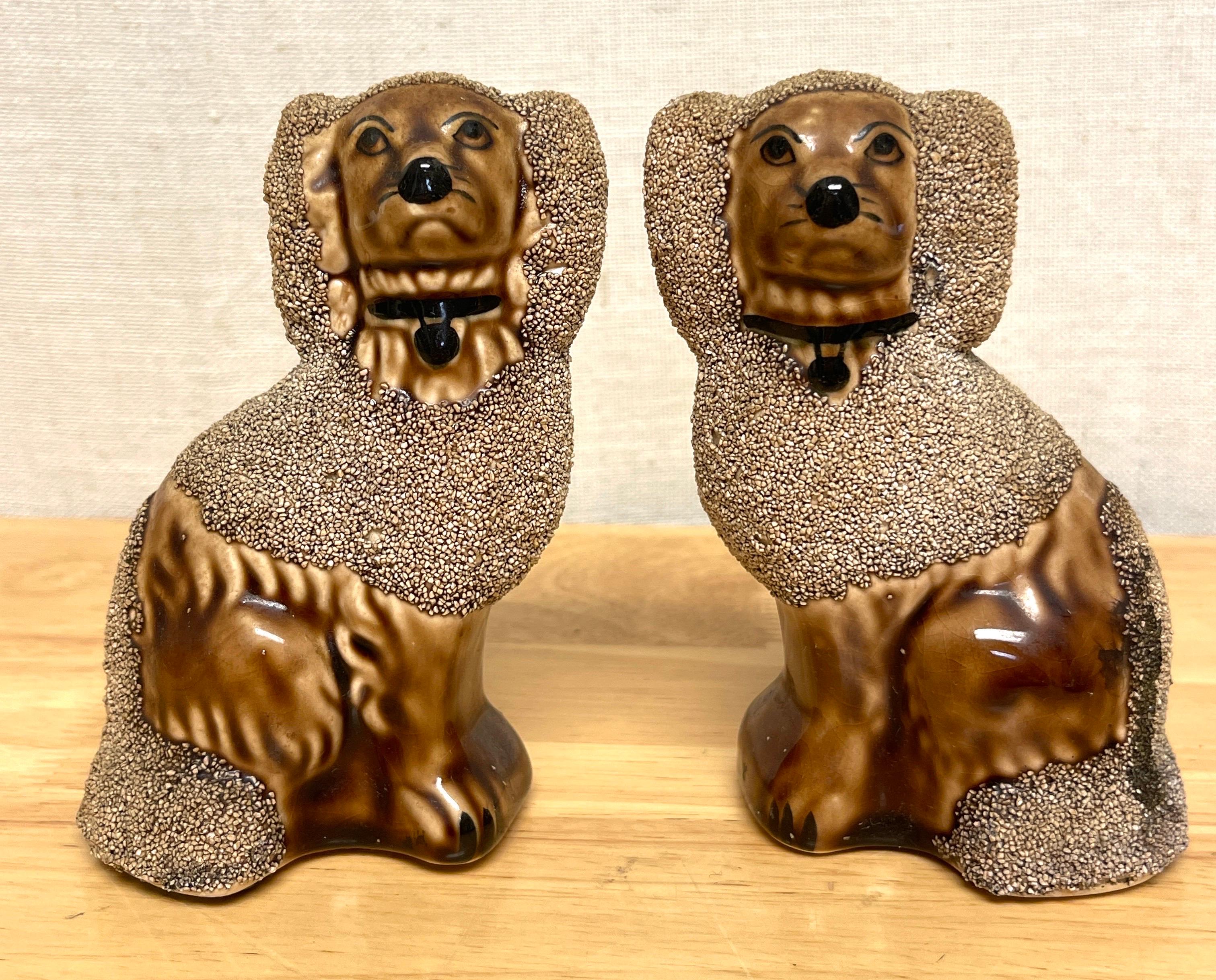 Pair of Diminutive Bennington Style Rockingham-Glazed Figures of seated Poodles 
USA, 20th 1950s

A charming later version of Bennington pottery works, Each diminutive seated poodle realistically modeled, glazed in earth-tone brown Rockingham