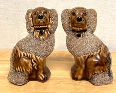 Pair of Diminutive Bennington Style Rockingham-Glazed Figures of Seated Poodles