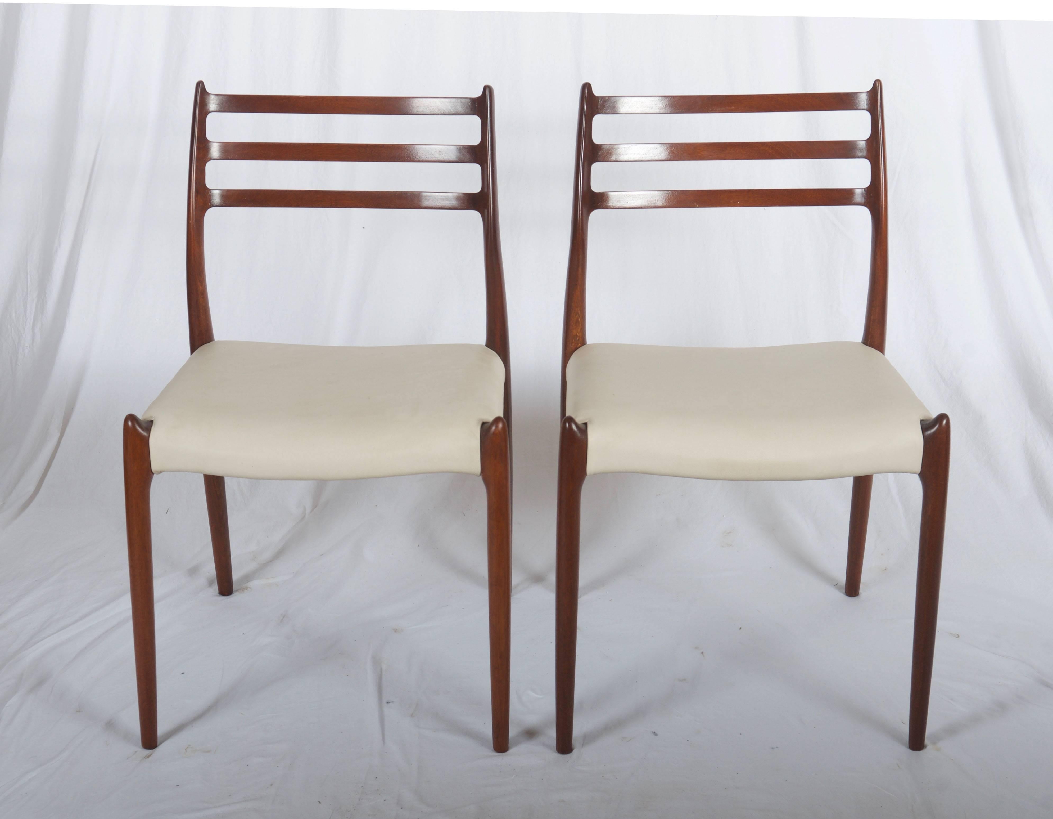 Dining chairs made of solid teak, designed in the 1950s by Niels Otto Møller and produced by J. L. Møller Møbelfabrik, model number 78. Fully restored, wood surface glossy finish with new fabric leather upholstered seat. Delivery time about 2