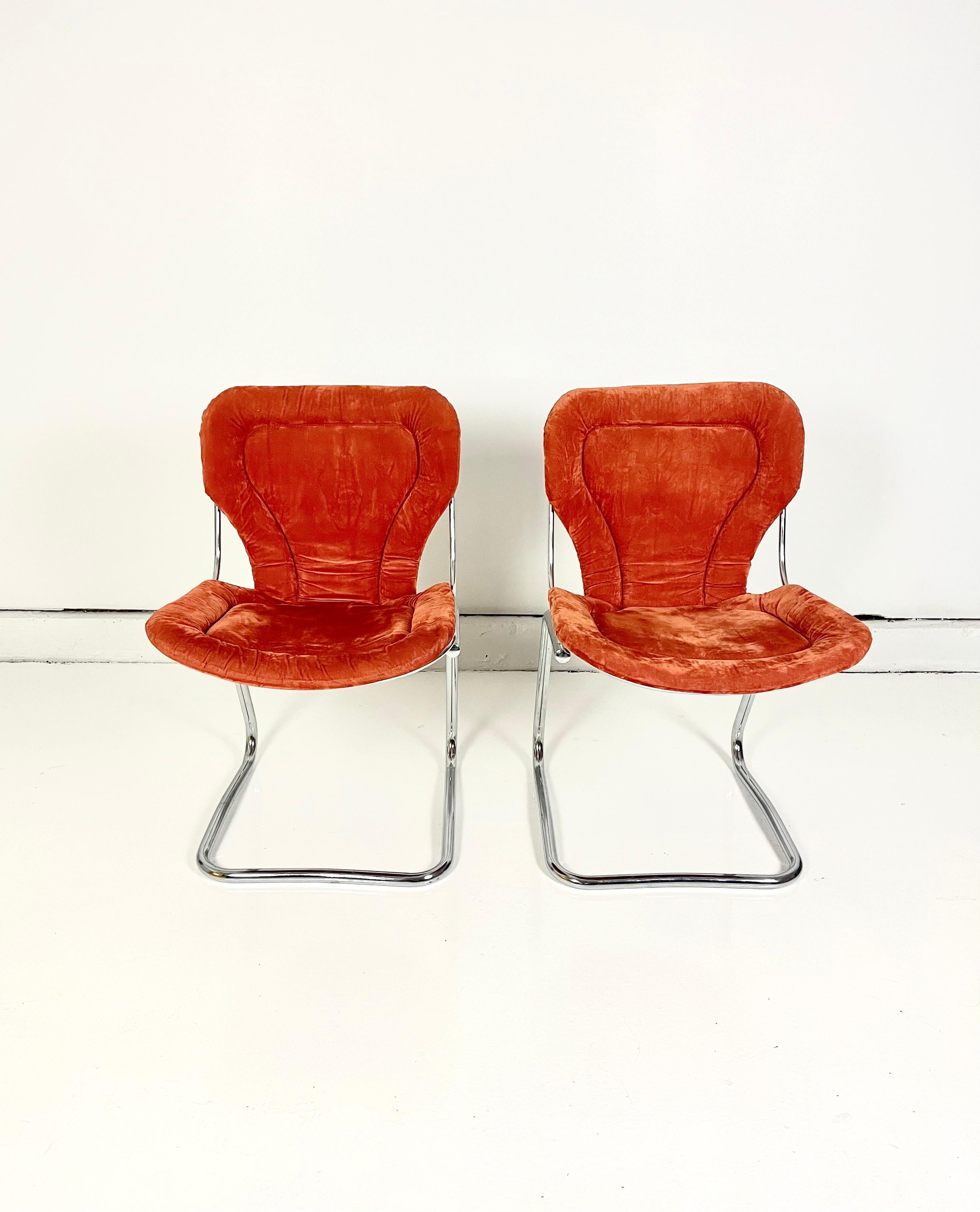 Chrome-plated steel wire frames with detachable orange cushions. Sold in pairs.