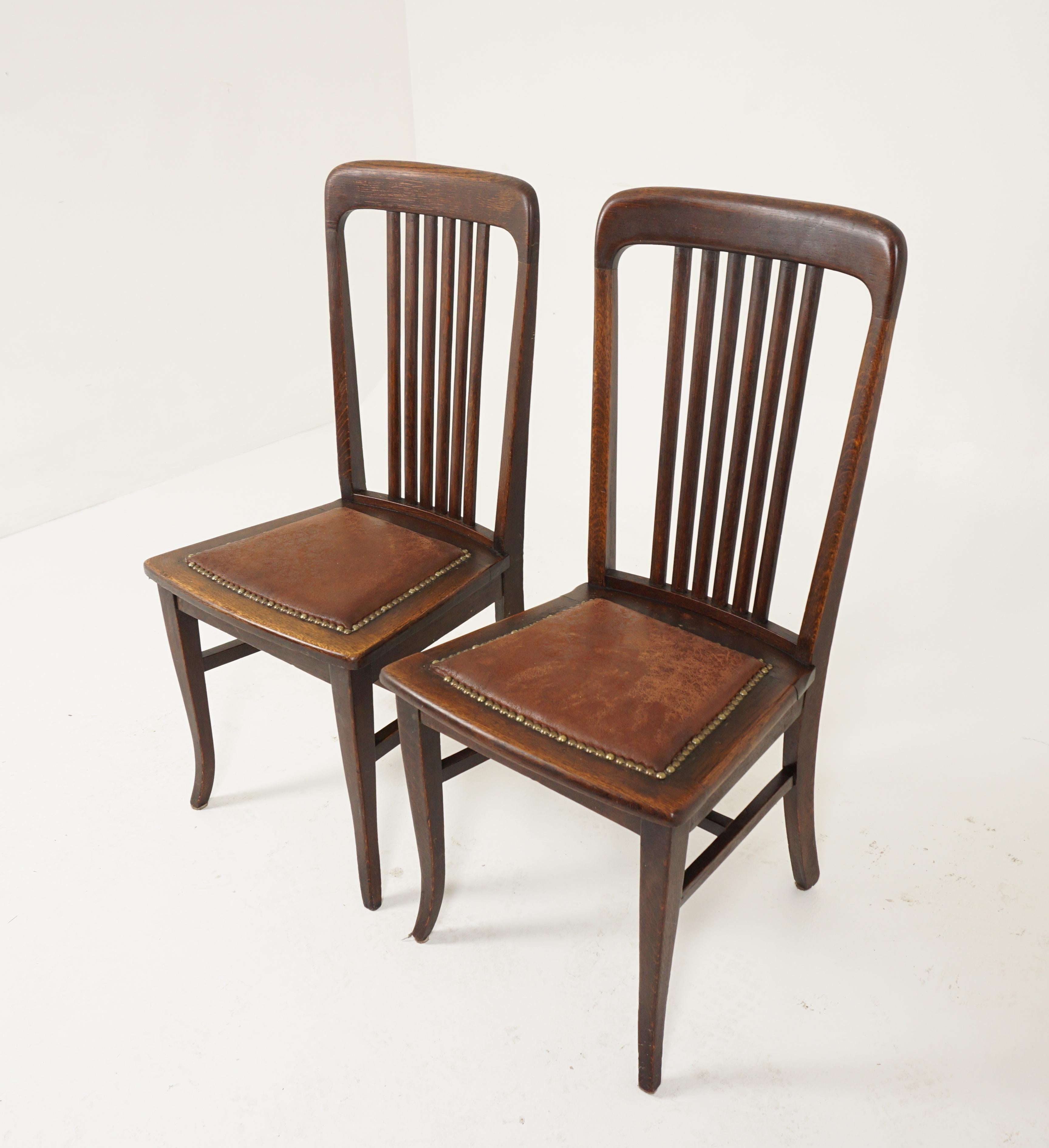 Pair of dining chairs, tiger oak, upholstered seat, American 1920, B2480A

American 1920
Solid oak
Original finish
Rounded top rail 
Six vertical slats to the back 
Upholstered leather seat 
Splayed out tapered legs to the front
Connected