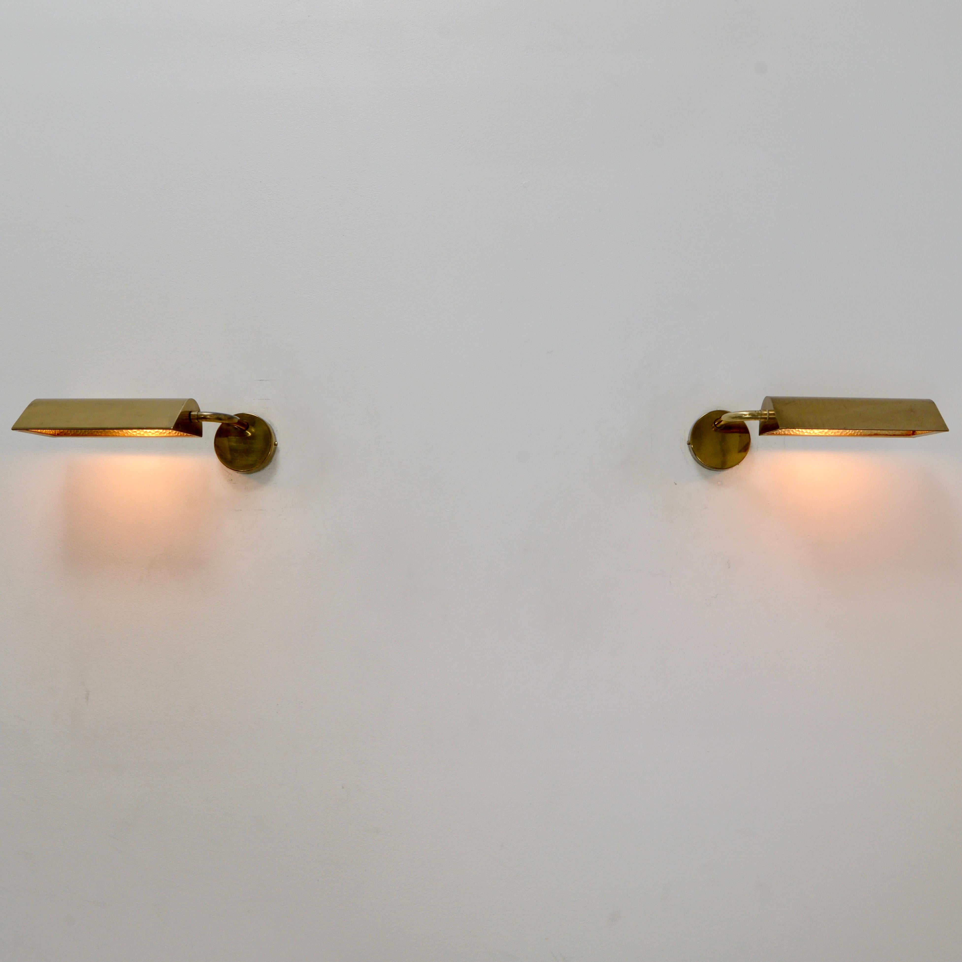 Pair of all brass Directional Italian sconces with original finish from the 1950s. Partially restored. (1) E26 medium based socket per sconce with tubular light bulb. Wired for use in the US. Lightbulbs included with order. Sold as a