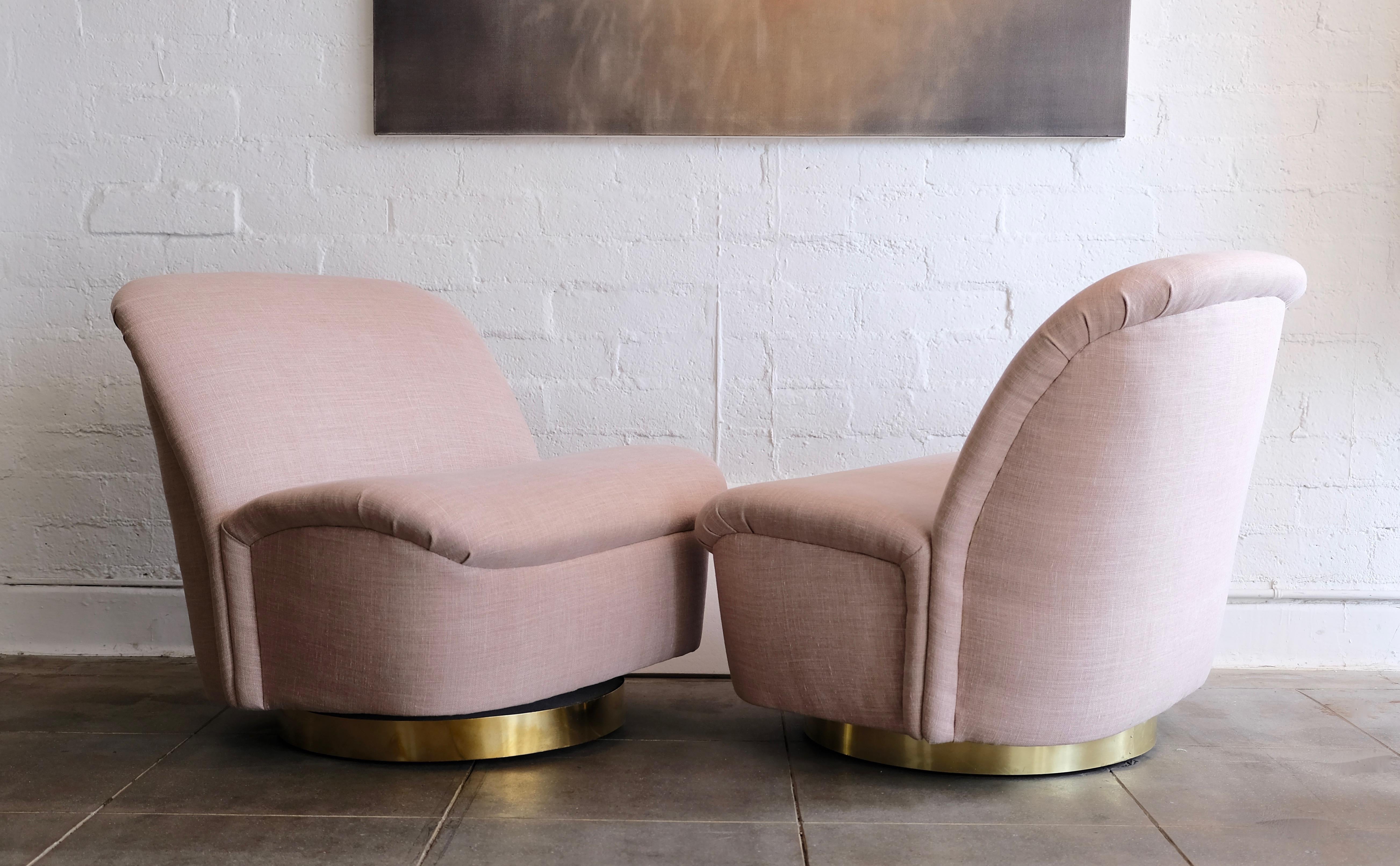 American Pair of Directional Swivel Lounge Chairs in Pink with Brass Base