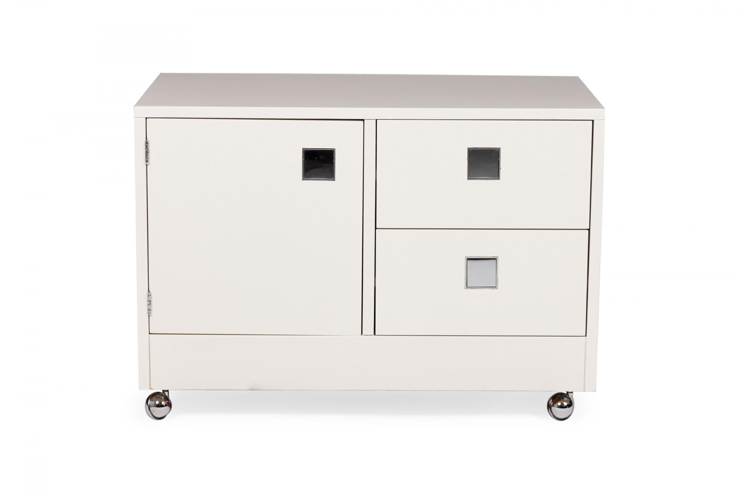 PAIR of American Mid-Century white laminate bedside tables / commodes with one large cabinet and two adjacent drawers, each with a square chrome inset, resting on four silver ball casters. (DIRECTIONAL)(PRICED AS PAIR)
