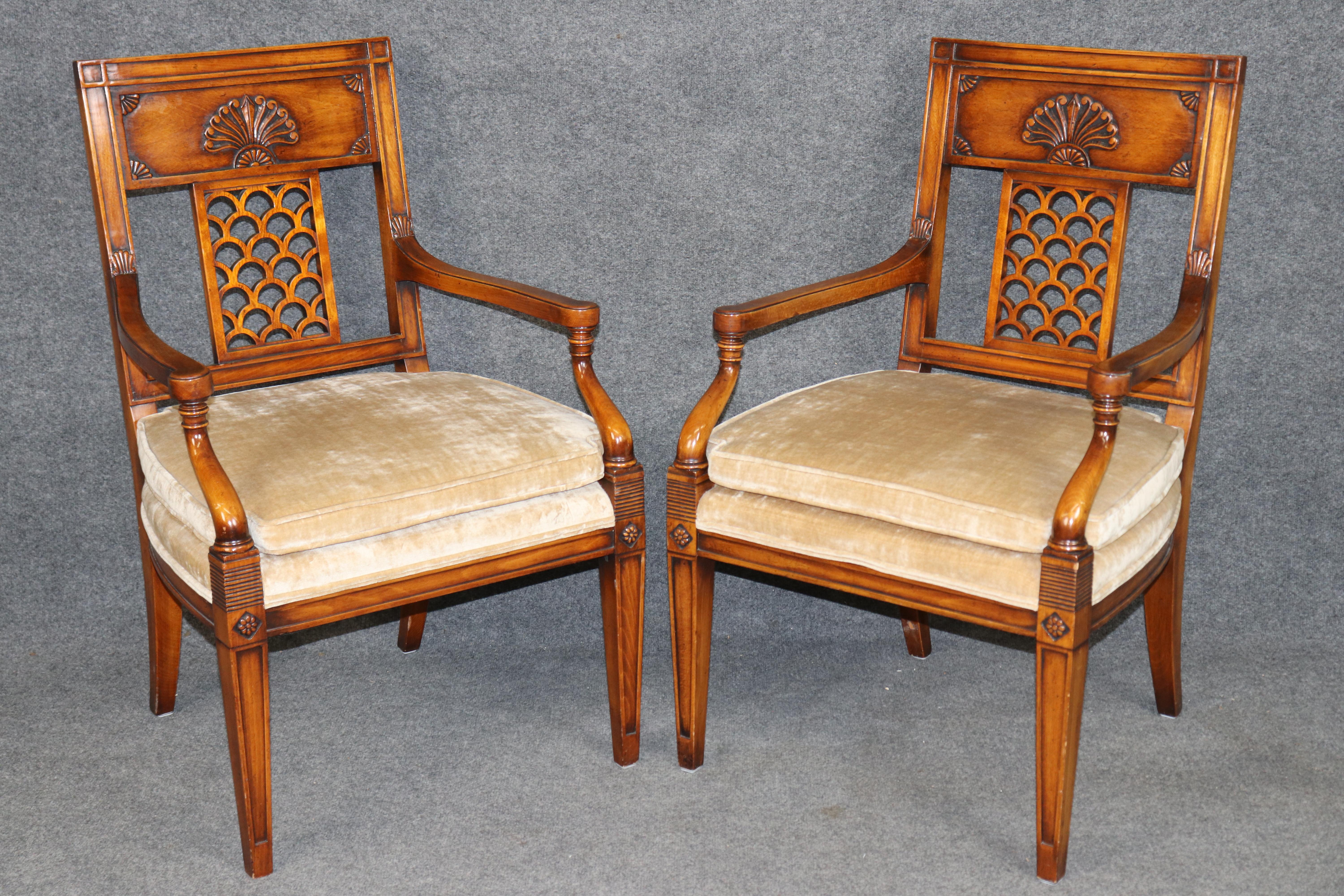 Dimensions - H: 27 3/4 in W: 24 in D: 23 1/2 in SH: 19 1/4 in 

This striking pair of Directoire style carved armchairs, attributed to the renowned Theodore Alexander, exemplifies the refinement and symmetry of late 18th-century French neoclassical
