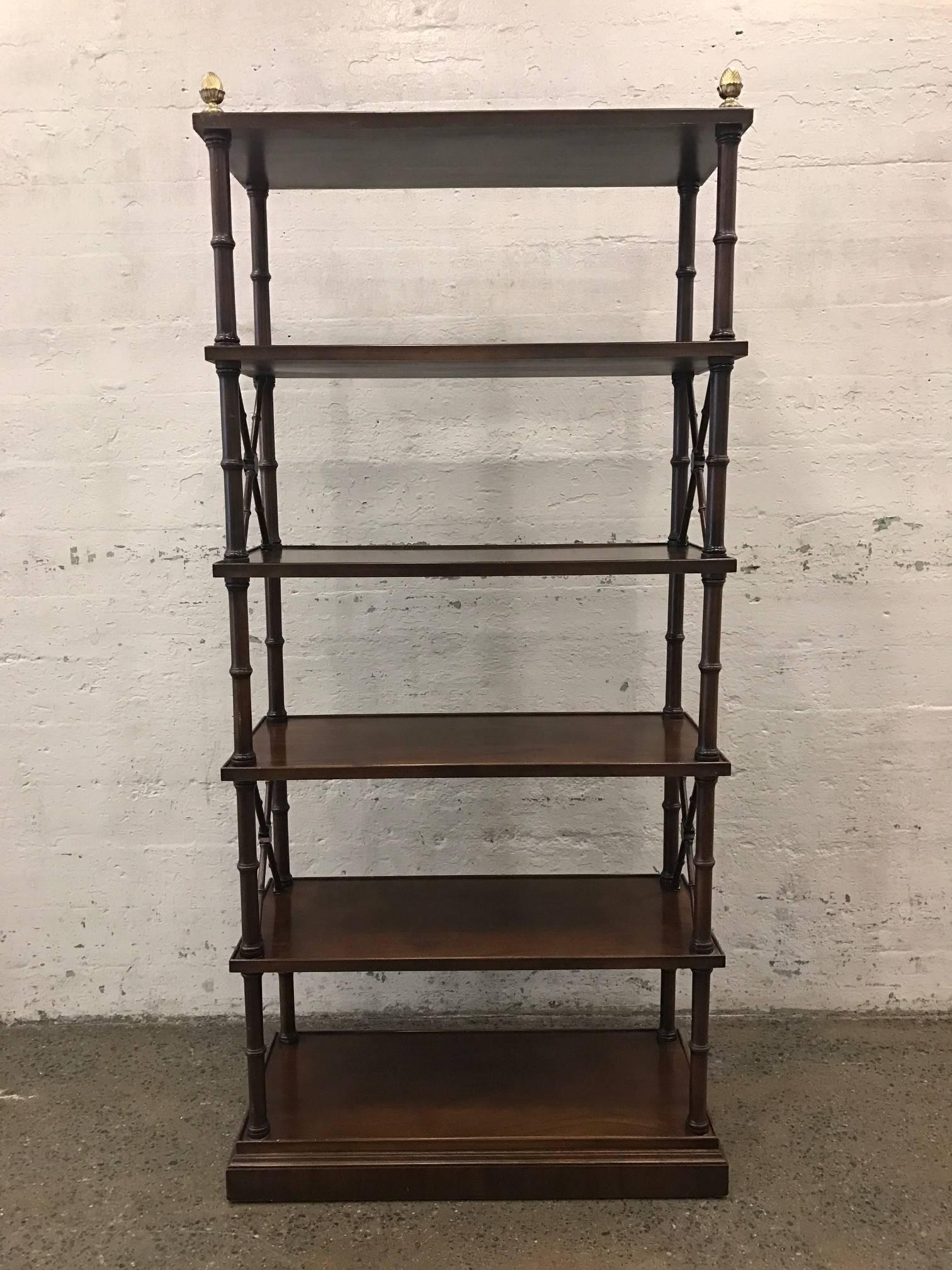 Pair of Directoire style mahogany étagères or bookcases. Has brass pineapple finials at the top.
