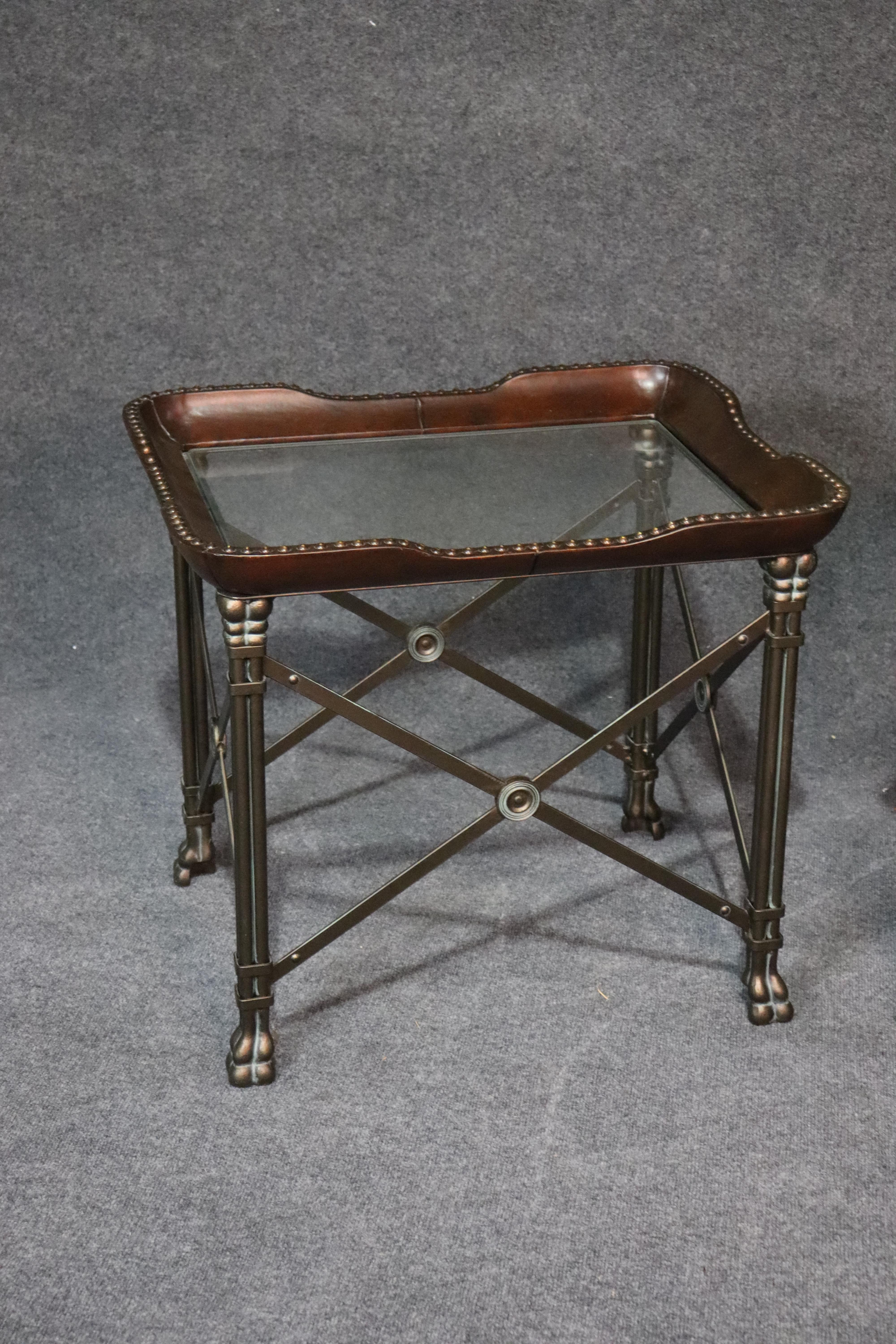 This is a superb pair of Maitland Smith style steel, leather bound and glass x form Directoire tables. They are very substantial and of the finest quality. They are unmarked but appear to be Maitland Smith as they ressemble closely their leather