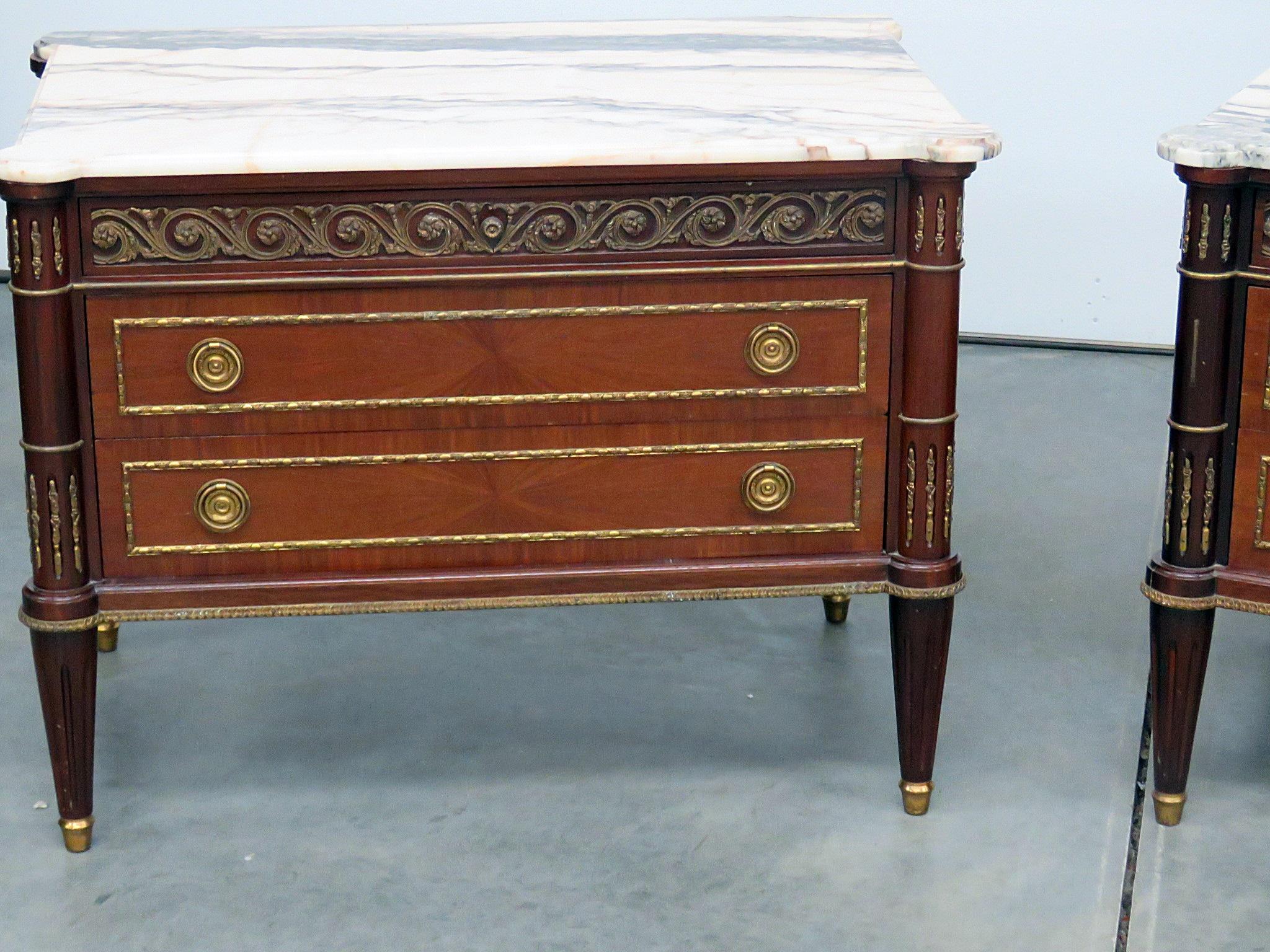 Pair of Directoire style 2-drawer marble-top commodes with gilt accents.