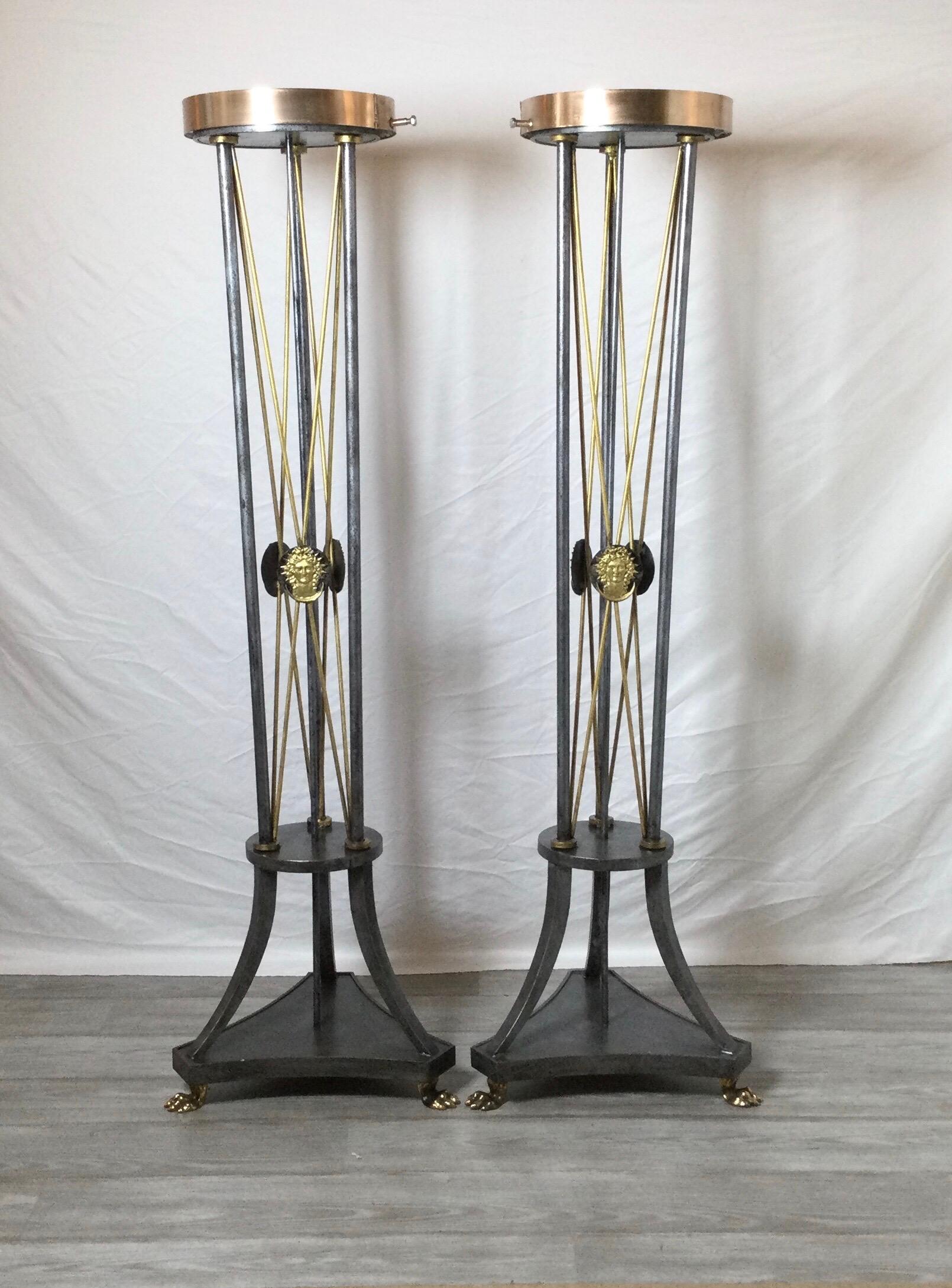 Pair Of Directoire' Style Tall Pedestal stands, Made of polished and painted iron with brass rods and paw feet. Structurally designed and made to hold and support heavy plants or objects.
Dimensions: 56.50