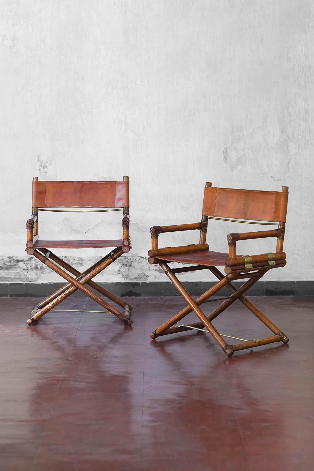 Pair Of Director’s Chairs By Elinor And John Mc Guire For Lyda Levi
Structure in very good condition. Light marks due to use and age on structure and leather seat. 
Made of bamboo and leather, San Francisco 1970.
Dimensions 60 W x 81 H x 50 D