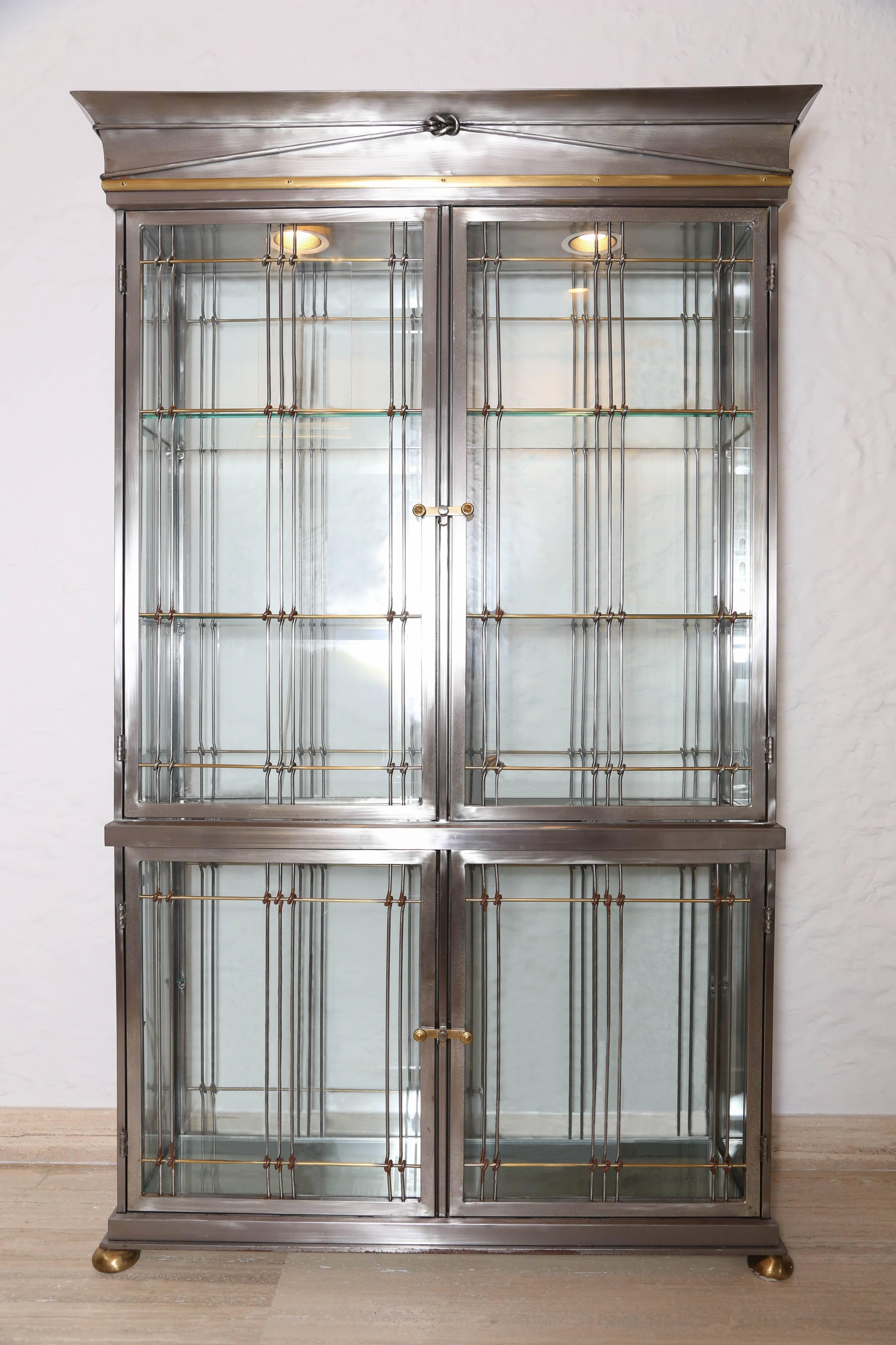An elegant pair of four-doors display cabinets in stainless steel and glass lighted from the top parts. Commissioned pieces by Maison Jansen for Hermes New York.
Measure: Bottom part height 31 in, width 46 in, depth 18 in.
