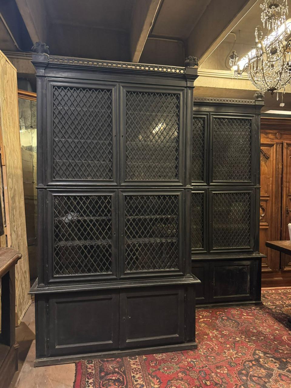 Antique Pair of display cabinets, made of black lacquered wood with a carved upper part with fruit baskets, 4 upper doors with mesh glass and 2 doors in the lower closed part, from a castle in Turin (Italy), original from the 19th century and