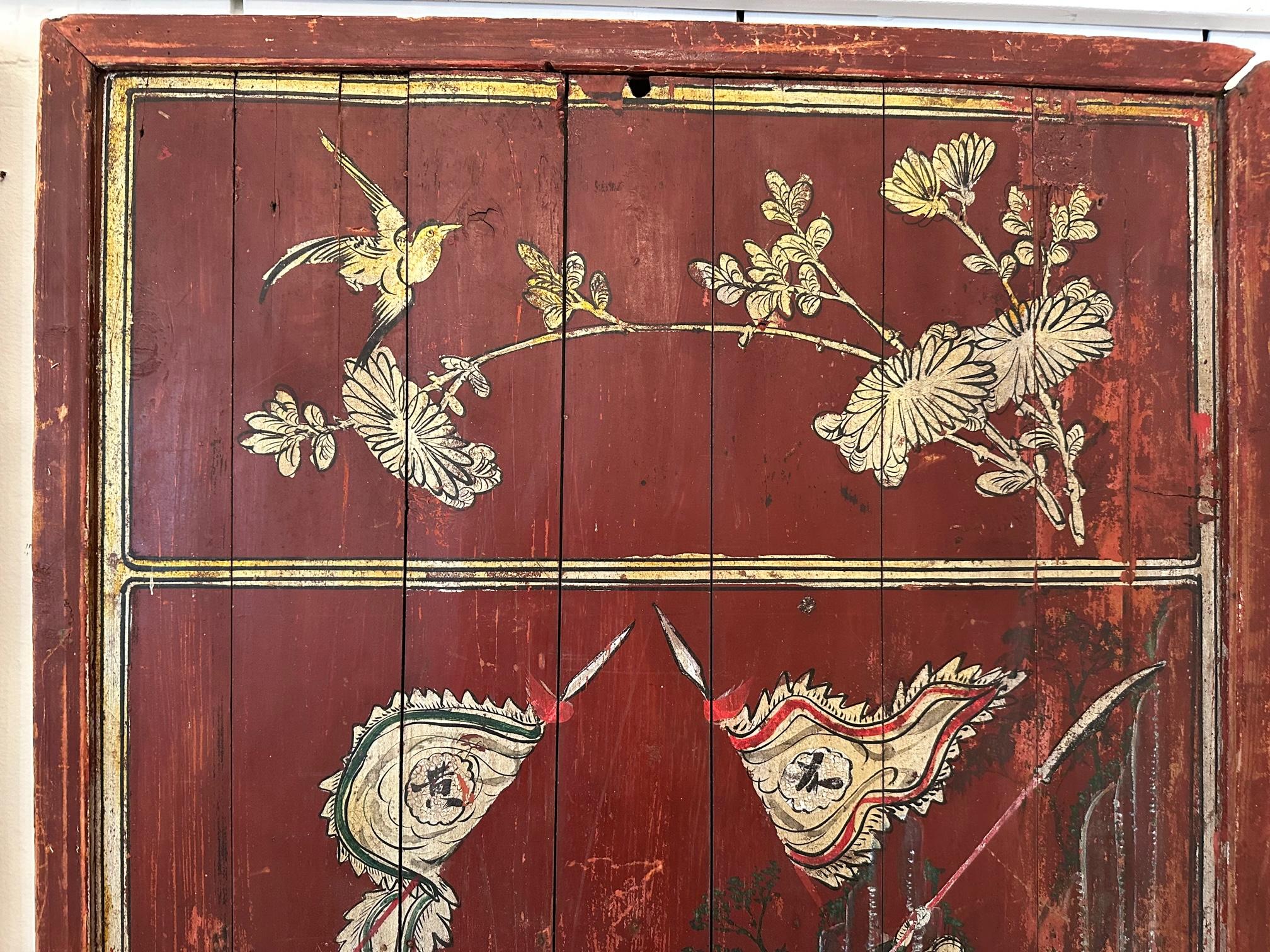 Stunning pair of distressed antique Chinese hand painted wooden panels having red backgrounds and figural decoration of warriors on horseback in black, white and green.