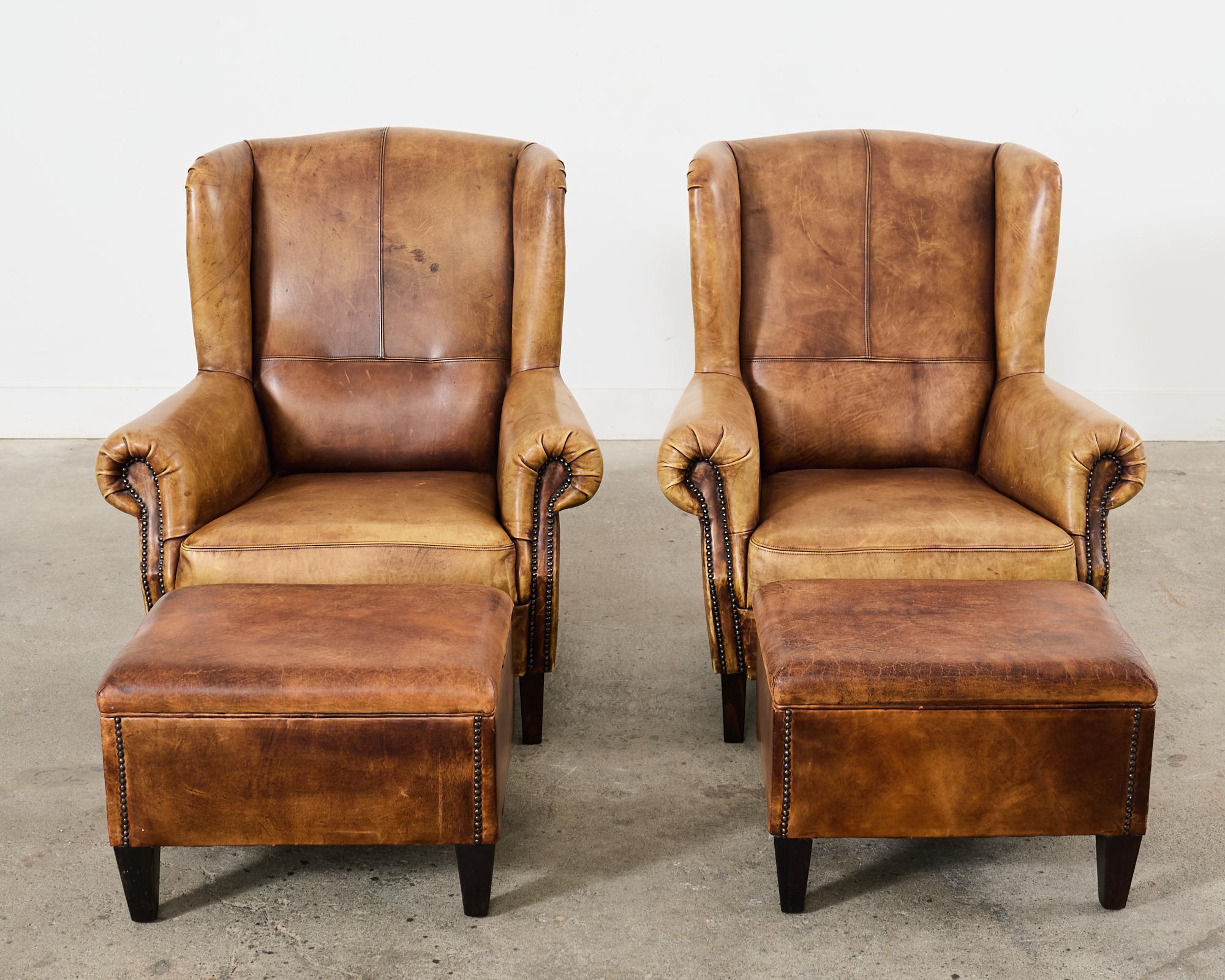 Rustic Pair of Distressed Cigar Leather Wingback Chairs with Ottomans