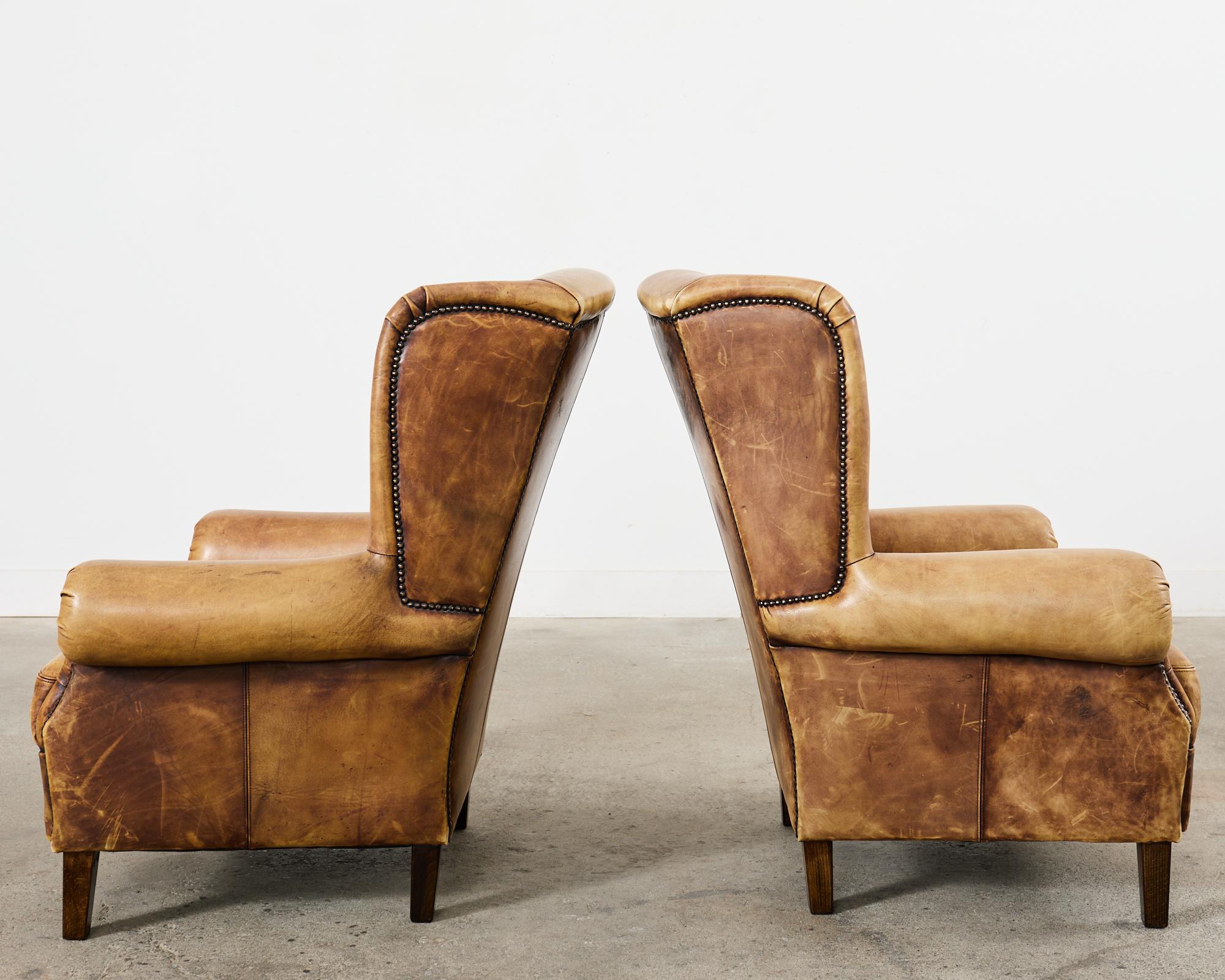 Pair of Distressed Cigar Leather Wingback Chairs with Ottomans In Distressed Condition In Rio Vista, CA
