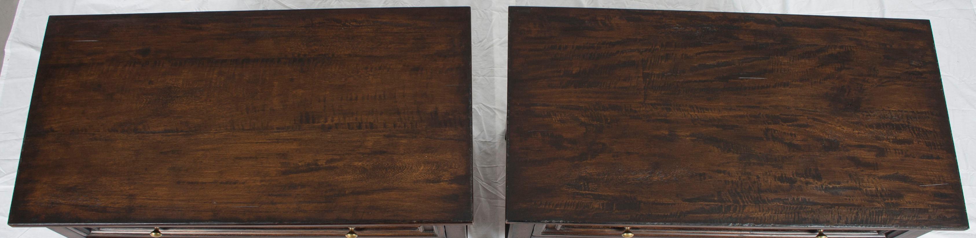 Perfect for either side of a bed or any situation where a pair of chests are needed, this reproduction pair of nightstands are quite beautiful. Rustic pecan has been used to lovely effect on the drawer fronts, frame, and chest tops. Also, applied