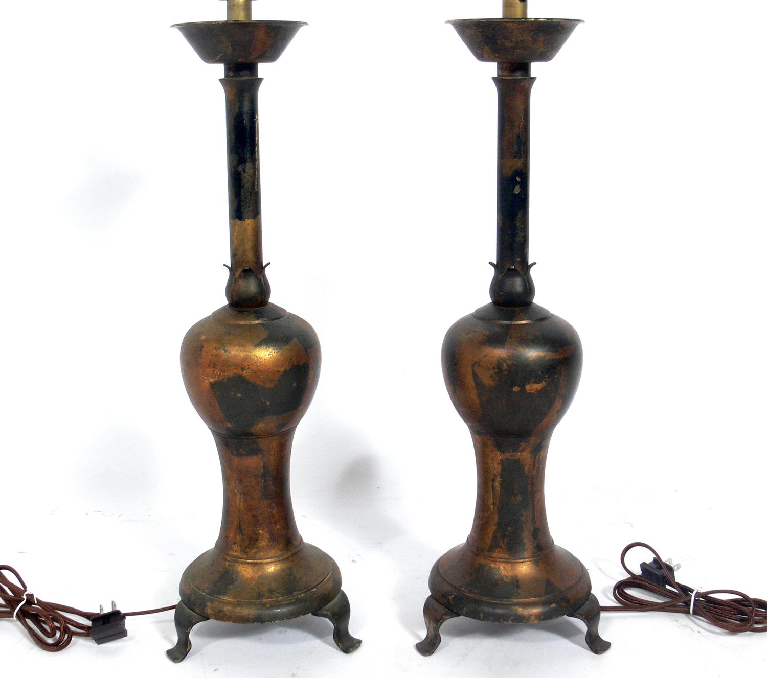 Pair of distressed gilt metal Asian lamps, probably Chinese, circa 1950s, possibly earlier. They have been rewired and are ready to use. The price noted below includes the shades.
