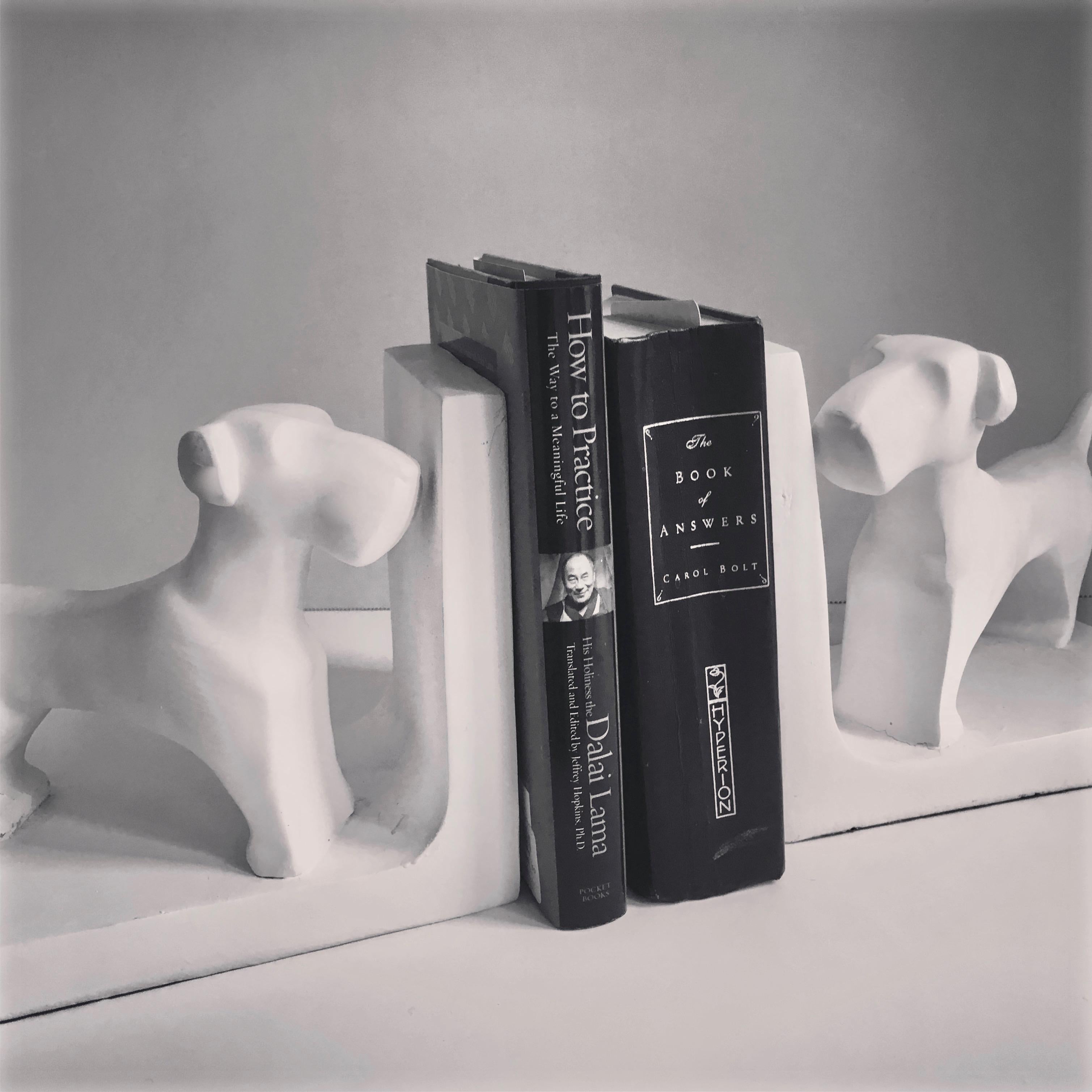 Pair of dog bookends. A handsome and charming representation of a Dog. in the manner of John Dickson by use of a Gesso look. Great for any shelf or desk and especially suited for the Childs room.