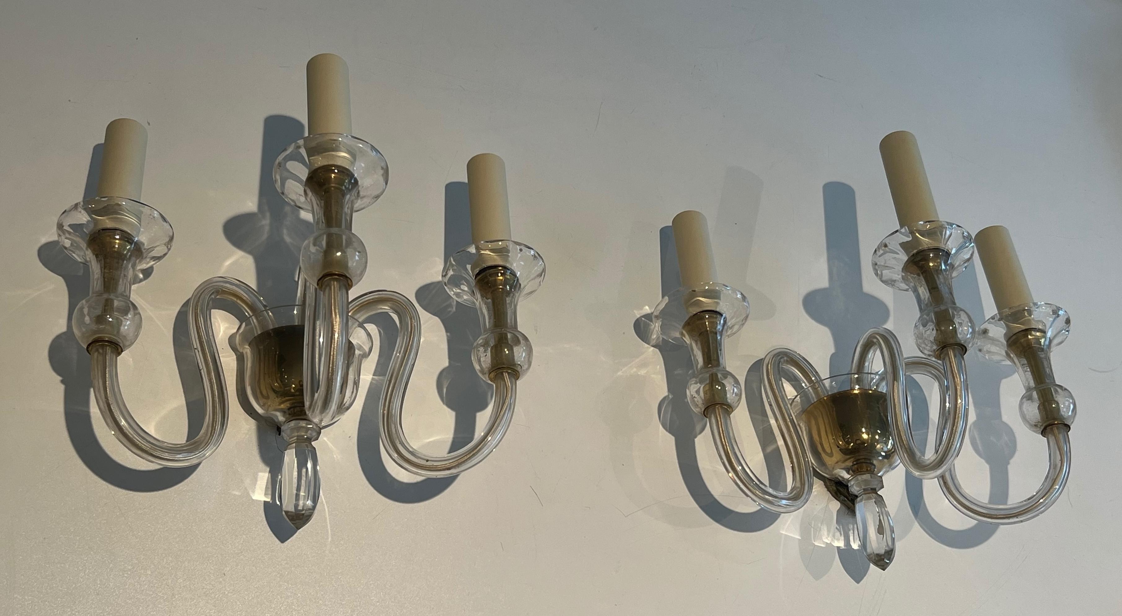 This pair of dolphin wall sconces is made of bronze. They are finely chiseled and represent dolphins. This is a French work by Maison Jansen. Circa 1940
