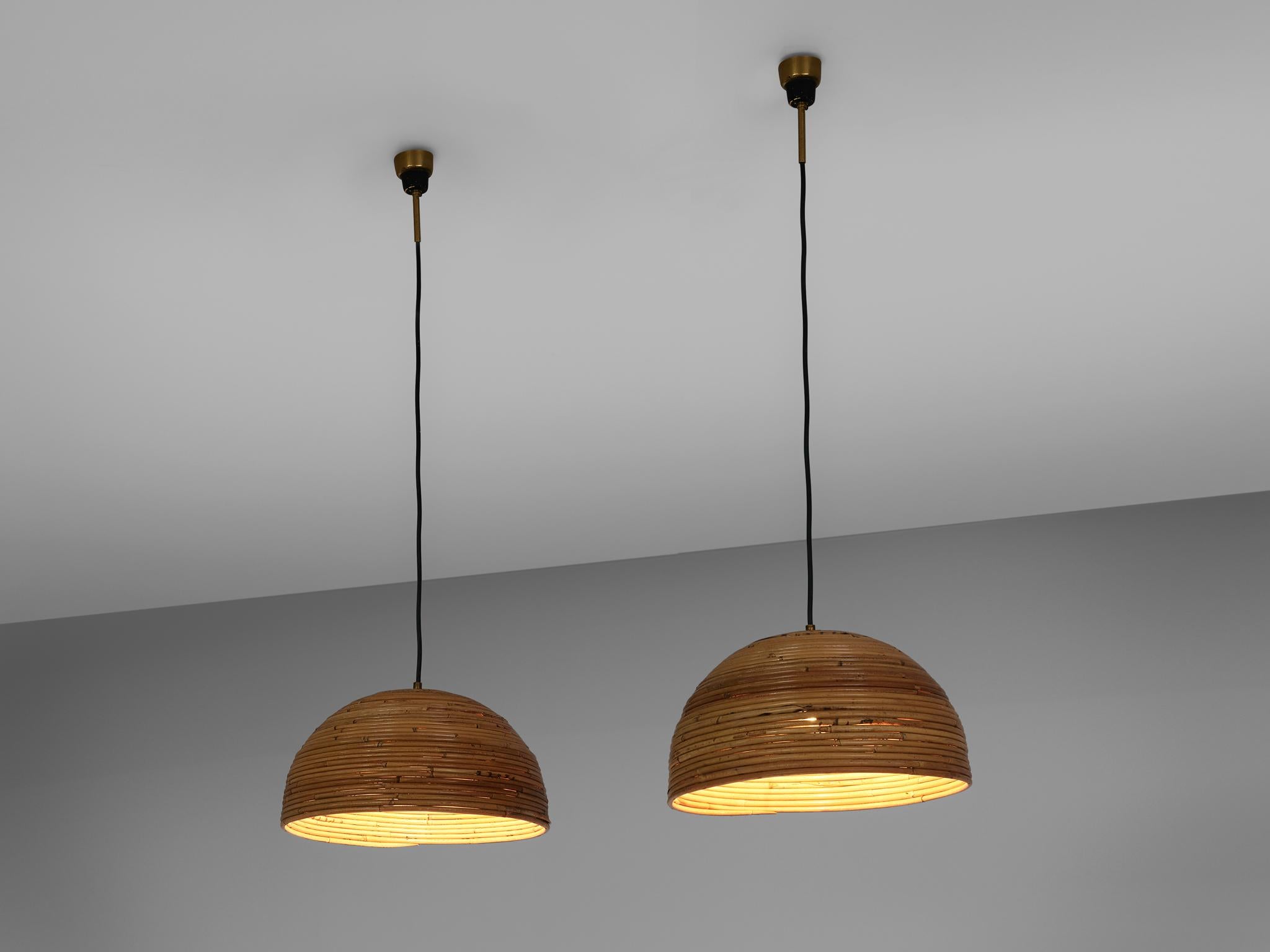 Pair of dome pendants, bamboo bentwood, brass, Europe, 1960s

This chandeliers are made out of bentwood bamboo which is layered horizontally and forms a dome shape light. The warm color of the natural material presents a soft lighting indoors as