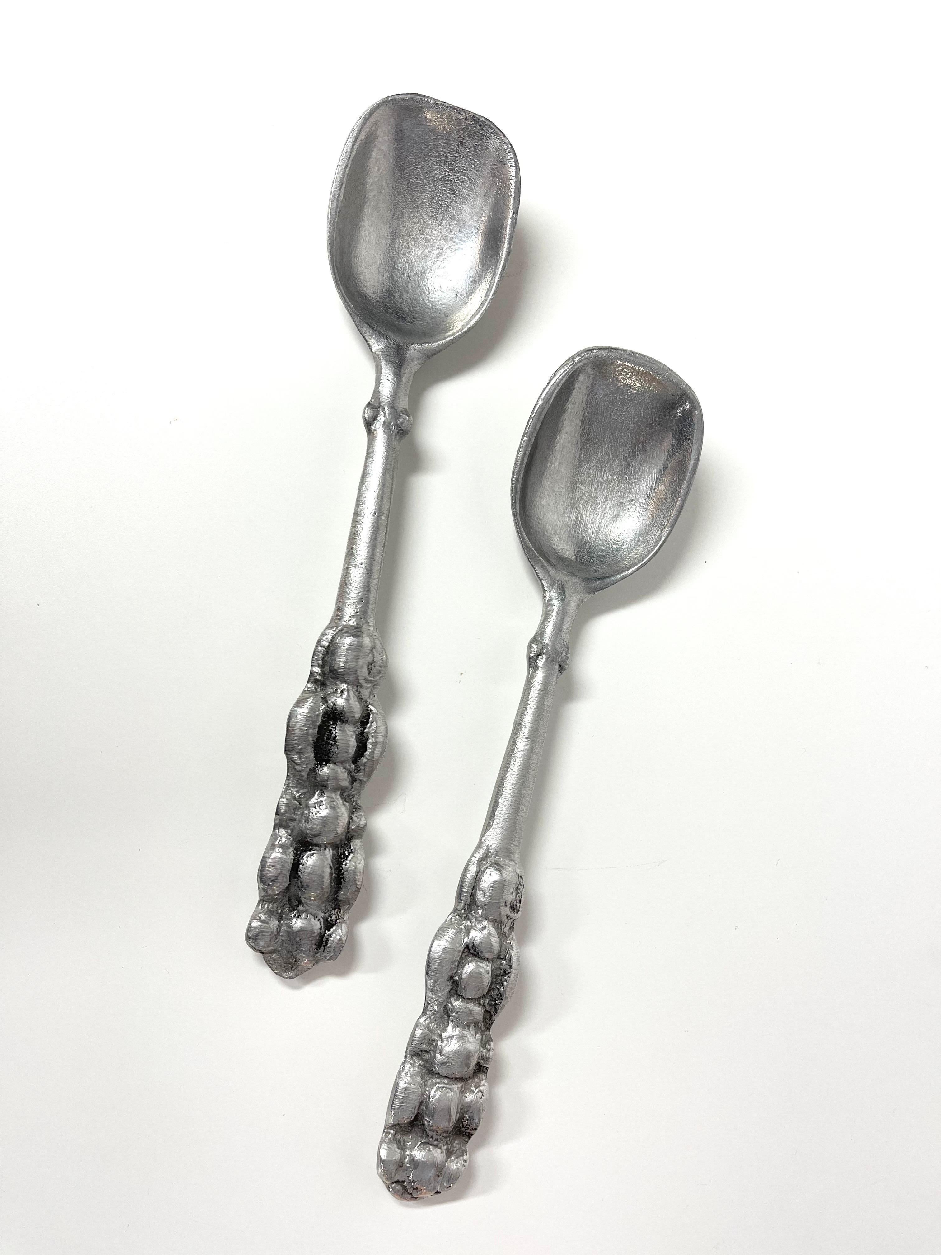 Pair of Don Drumm Bubble Spoons. Perfect for a collector. Use them as serving spoons or as salad tongs. Great Brutalist style in aluminum with bulbous handles.
Don Drumm was born in Warren, Ohio in 1935. After studying medicine for two years at