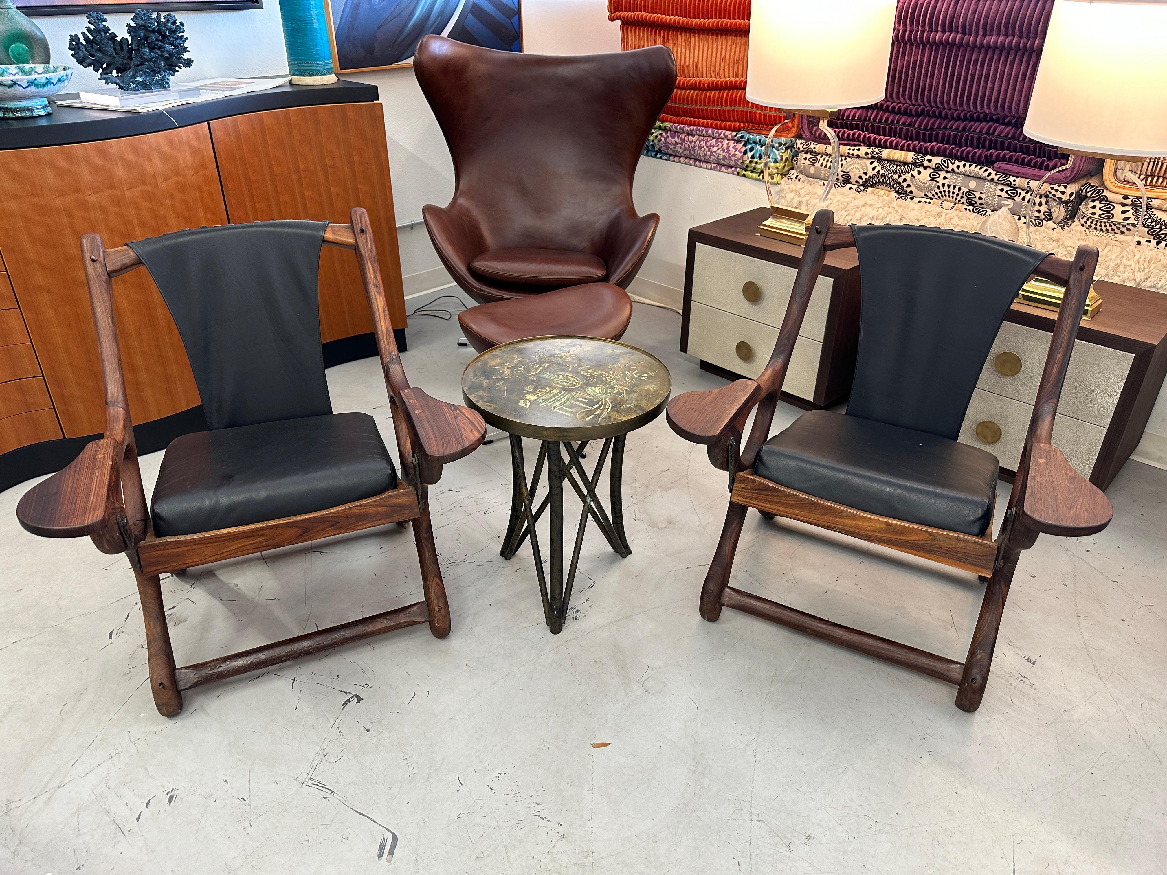 A quite lovely pair of Don Shoemaker sling chairs for his firm Senal from the 1960's. This pair is made of a Mexican Rosewood, Cocobolo I believe. The pair has beautiful graining and the leather sling and seat cushion are in good condition. One of