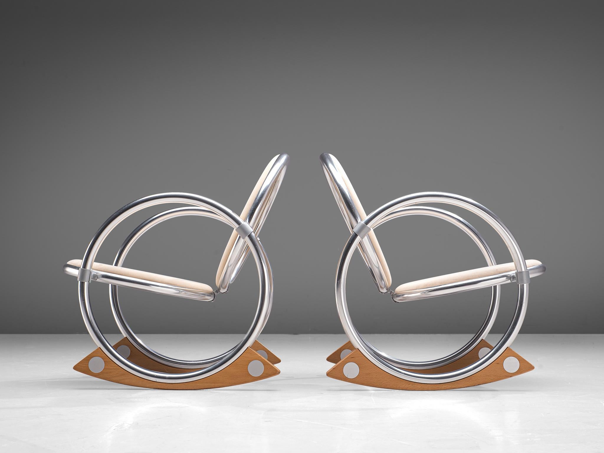 Verner Panton for Ycami Edizioni/Italy, pair of 'Dondolo' rocking chairs, aluminum, beech and fabric, Italy, 1990s.

Postmodern pair of rocking chairs, designed by Verner Panton. The chairs consist of four tubular circles. The two larger circles