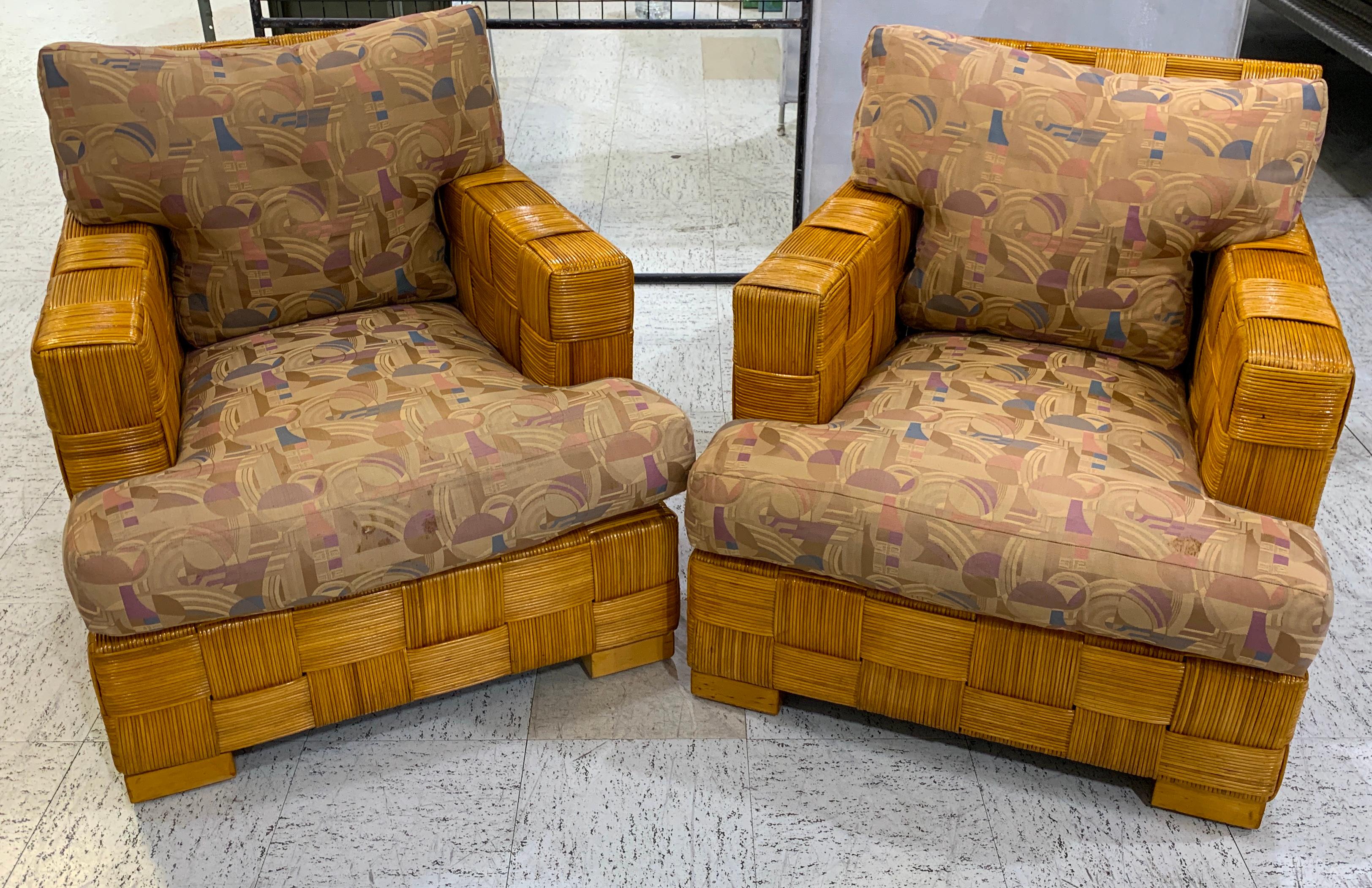 Pair of Donghia woven rattan block Island club chairs by John Hutton, Each one beautifully constructed and woven, warm even color and patina. Retains original Donghia fabric, useable or ready for upholstery. Stamped Donghia.