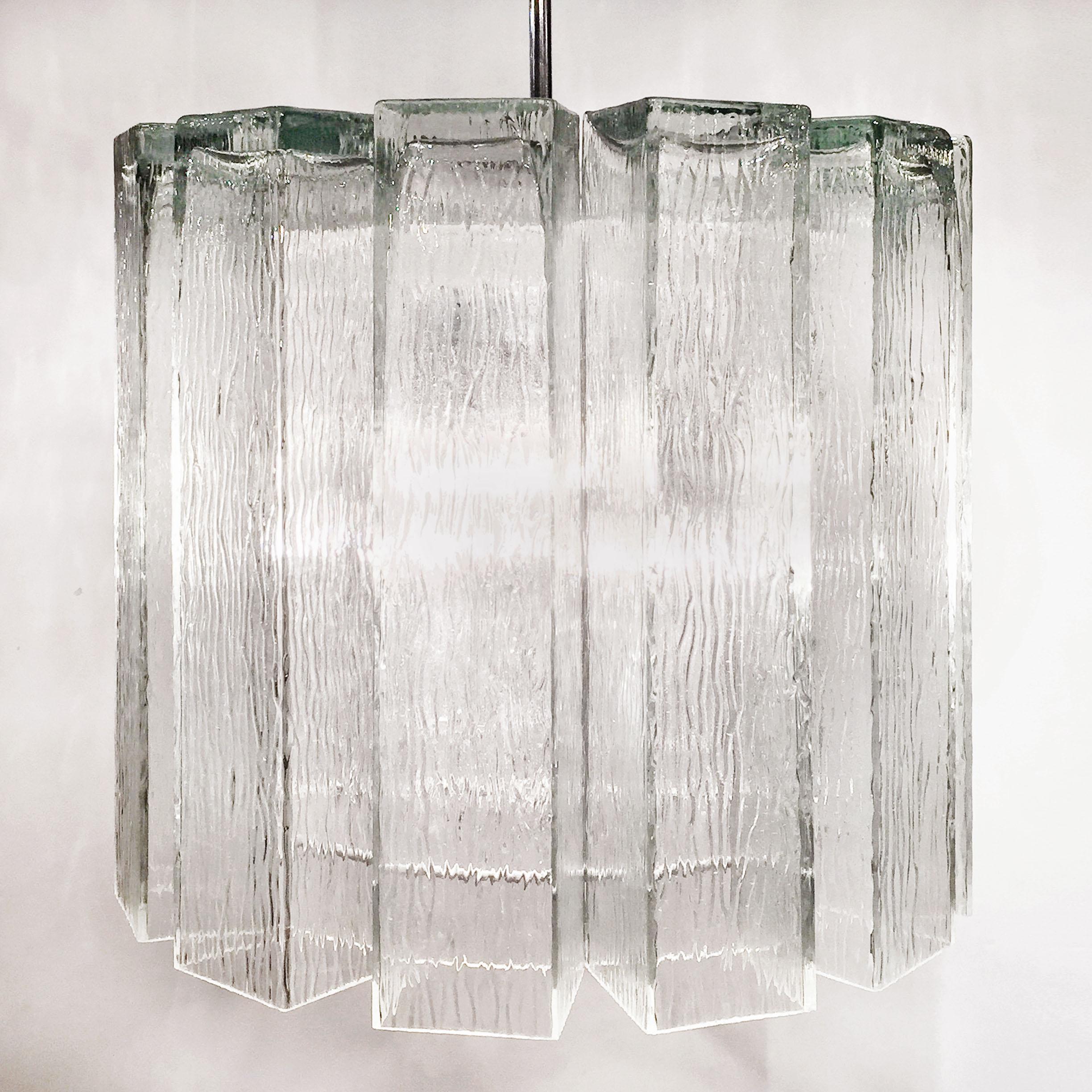 These exquisite 1970s Doria chandeliers feature 12 rectangular ice glass crystals that hang from a ring shaped fixture, centred by a chrome rod. Each fixture is equipped with 4 sockets.