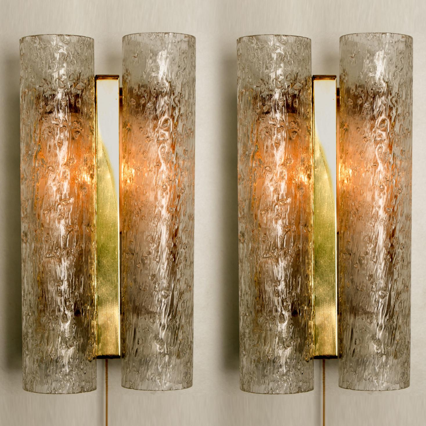 Wonderful pair off high-end Doria wall lamps. Manufactured in the 1960s. With textured and clear and amber spickled glass pipes
The stylish elegance of this lamp suits many environments, from Mid century to Hollywood Regency, from Danish modern to