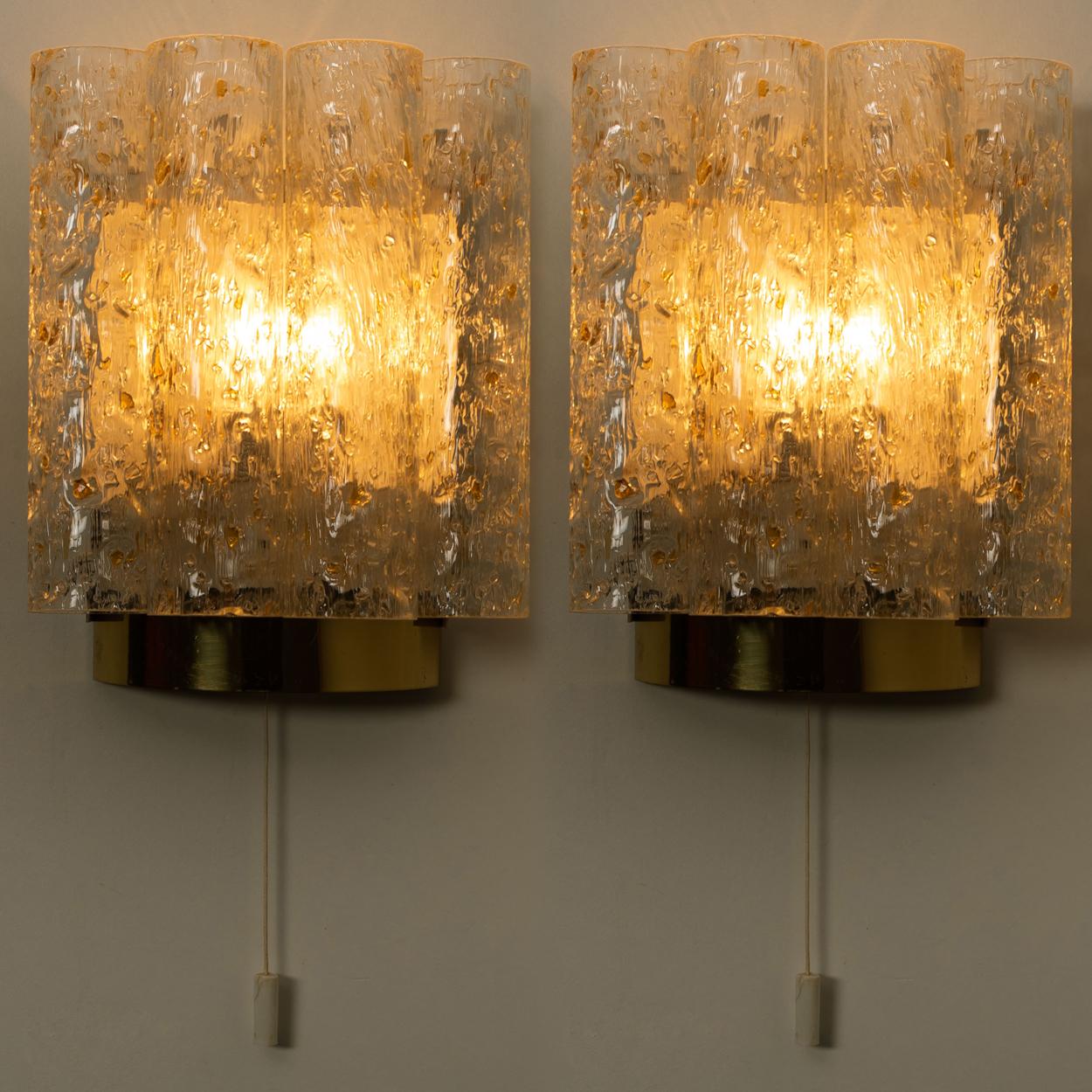 This wall lamps are designed by Doria. The wall fixture is made from brass, chrome (from the side) and metal and it features four thick hand blown glass tubes with gold flakes. Each wall lights takes an E14 max. 40W bulbs. Wonderful light effect due