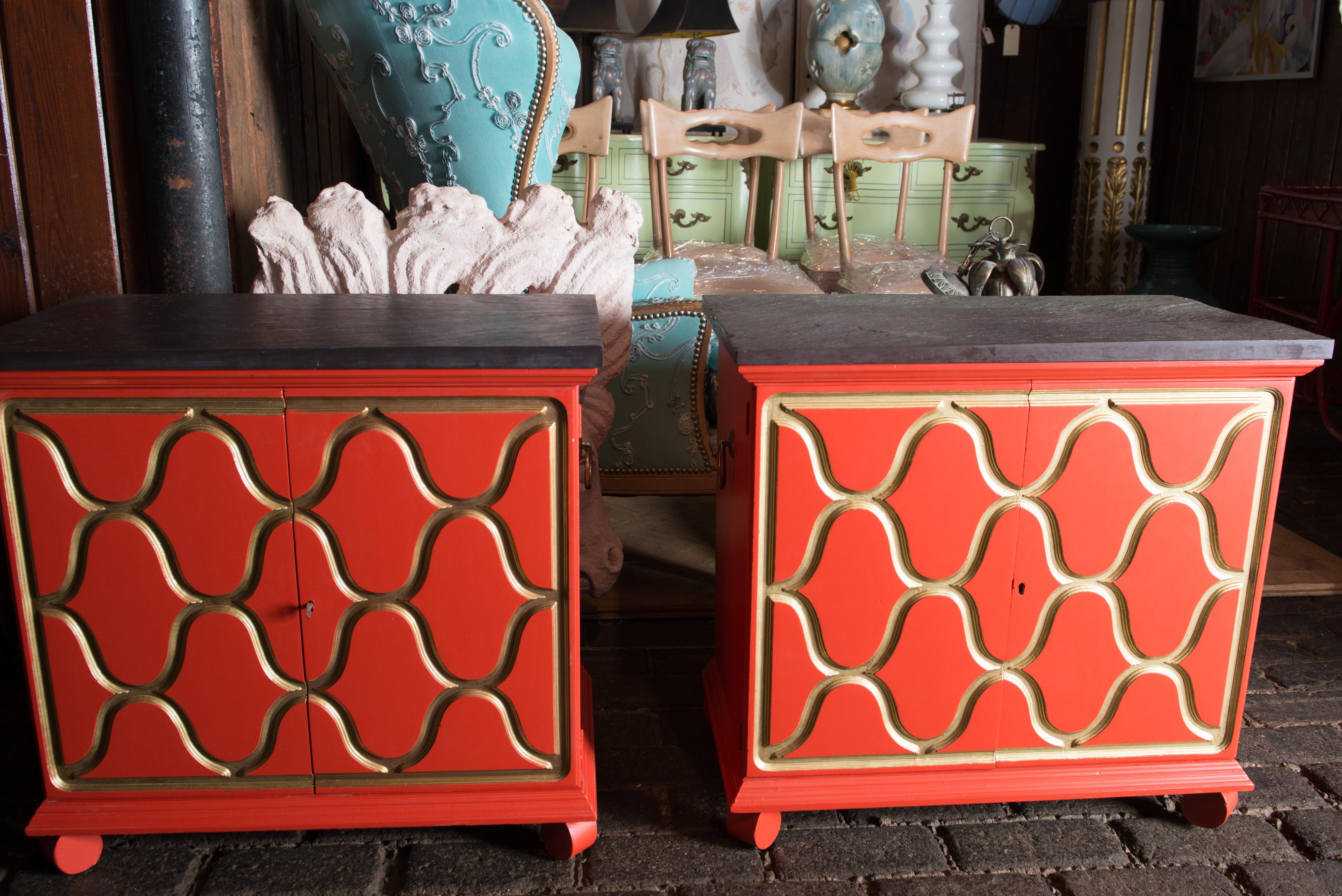 A pair of reddish-orange with gold trim Espana chests designed for Henredon by the premiere decorator, Dorothy Draper in the mid 1950s. They are finished with the original natural slate tops.