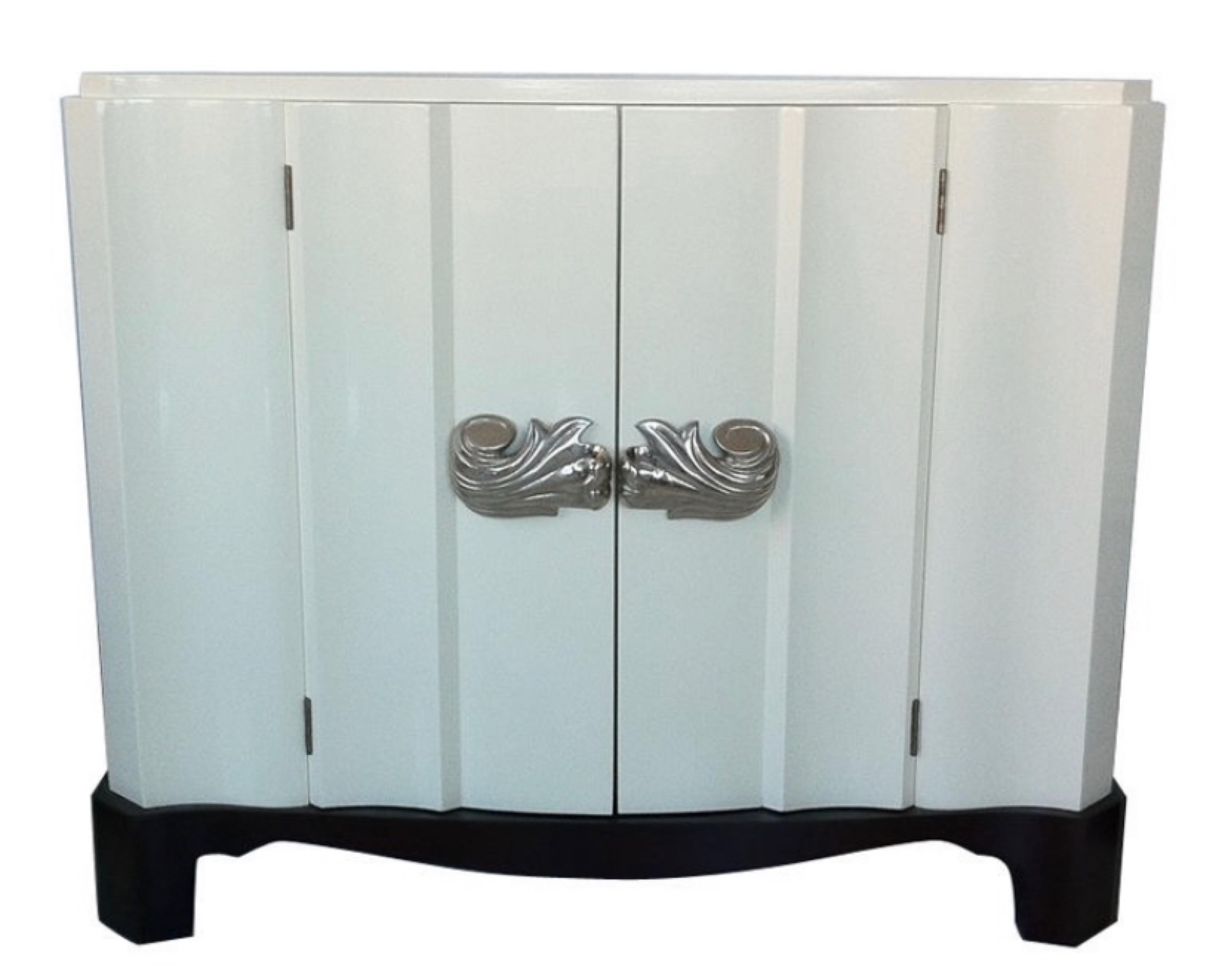 Stunning vintage Dorothy Draper serpentine cabinets in ivory lacquer with dark mahogany bases & beautiful silver nickel over bronze scroll pulls, circa 1940s. Great examples of Dorothy Drapers Modern Baroque style.

These chic chests could flank a