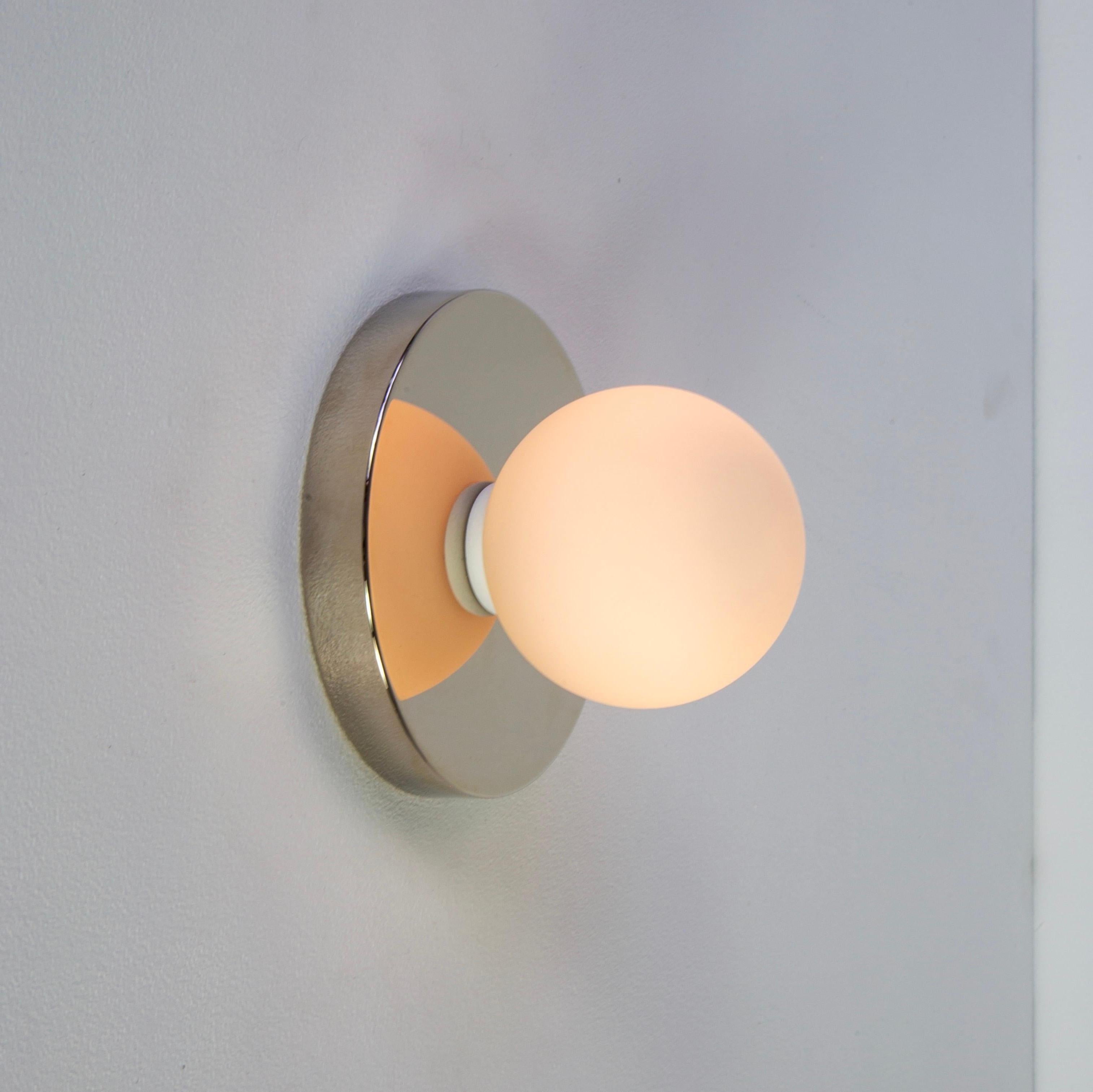 This listing is for 2x Globe Sconces in polished nickel designed and manufactured by Research.Lighting.

Materials: Brass, Steel & Glass
Finish: Polished Nickel 
Electronics: 1x G9 Socket, 1x 4.5 Watt LED Bulb (included), 450 Lumens
ADA Compliant.